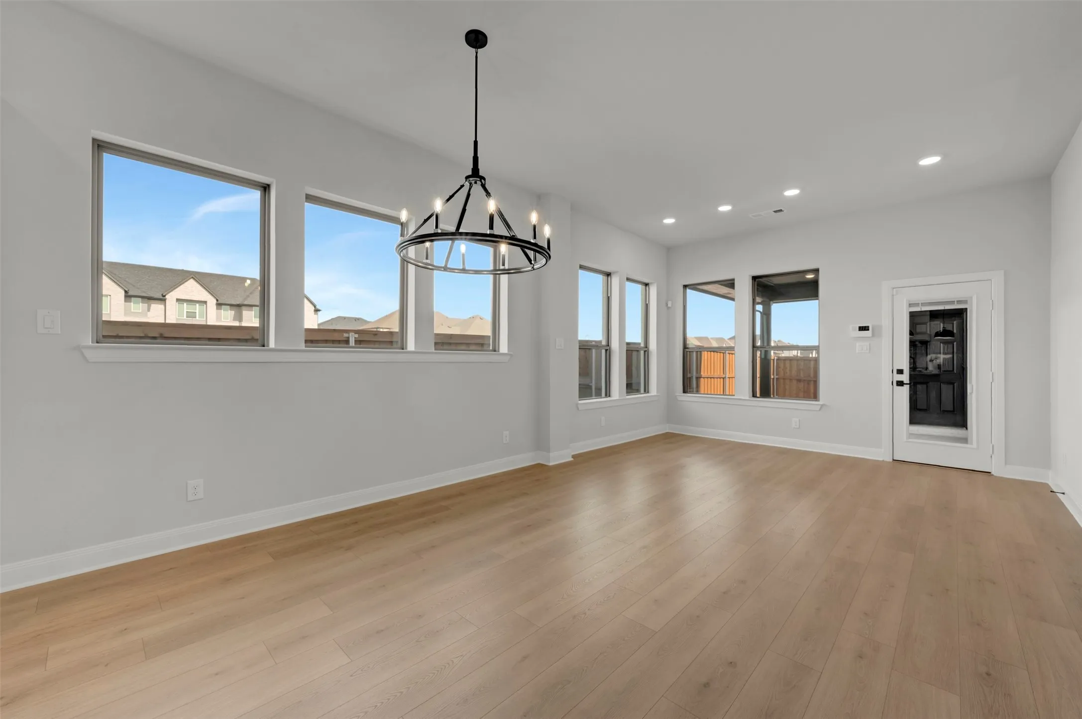 Unfurnished dining area featuring a chandelier and light wood-style flooring