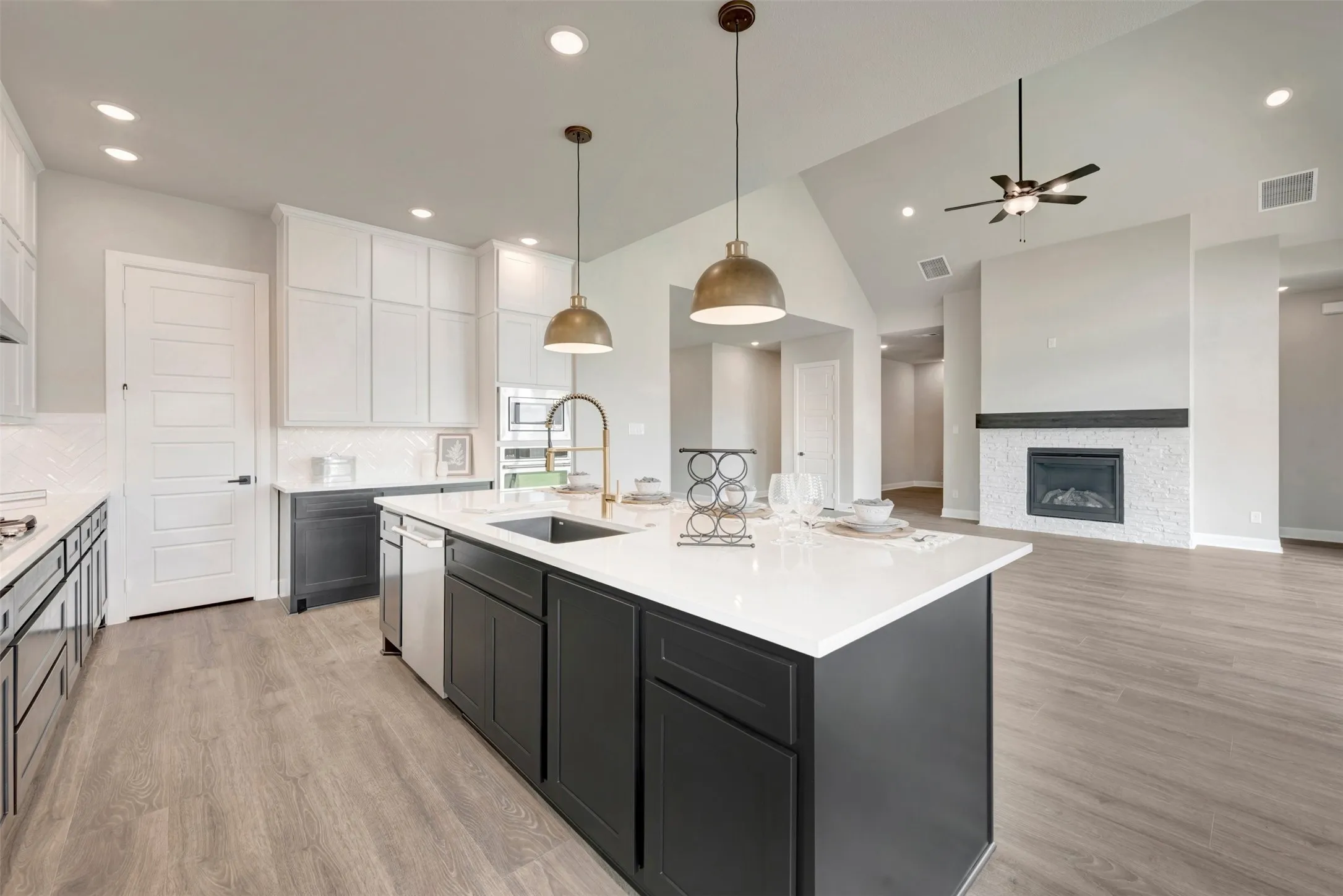 Kitchen island with a white countertop and dark cabinetry
