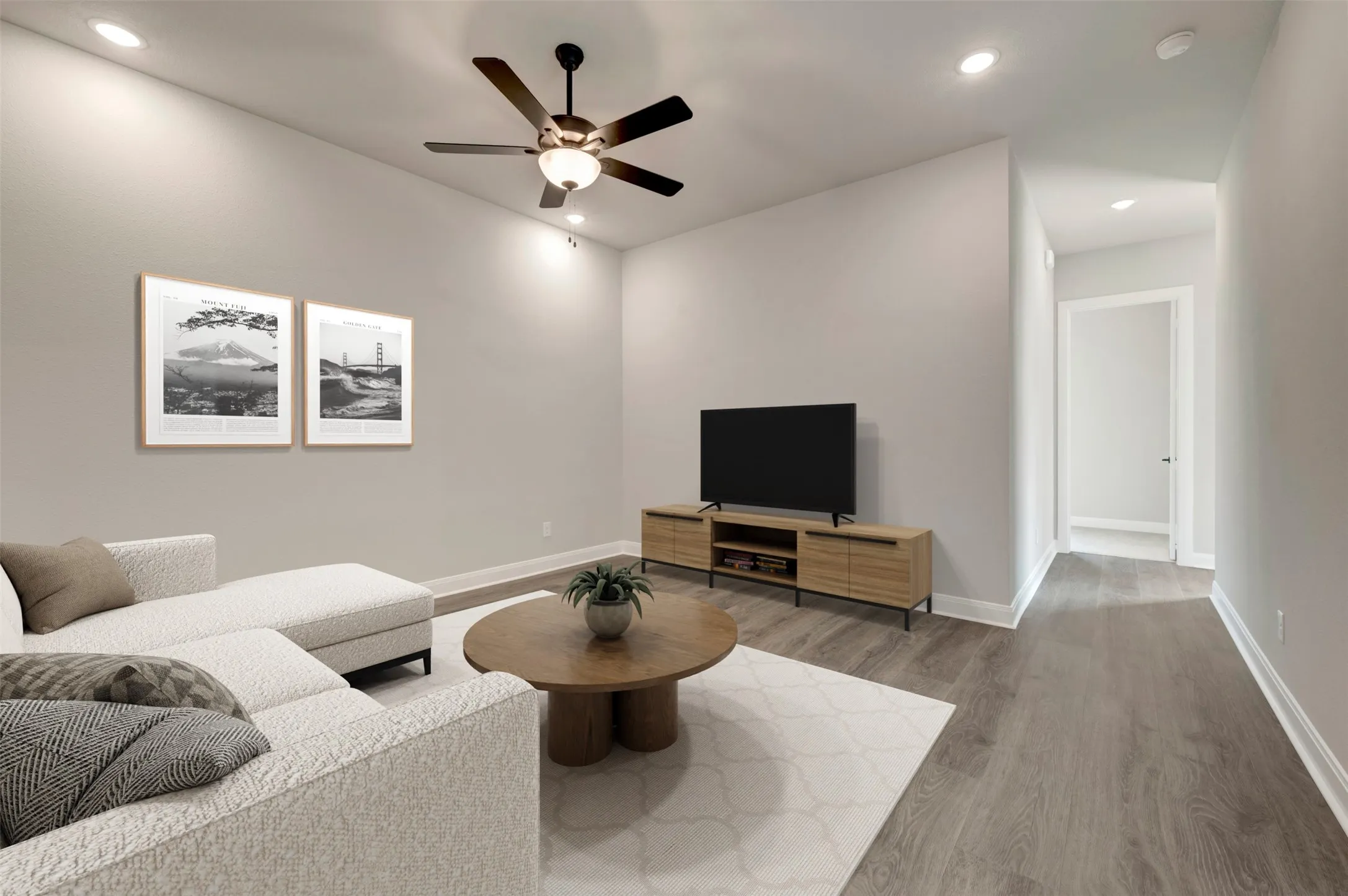 Spacious living area featuring high ceilings, recessed lighting, and wood-finish flooring