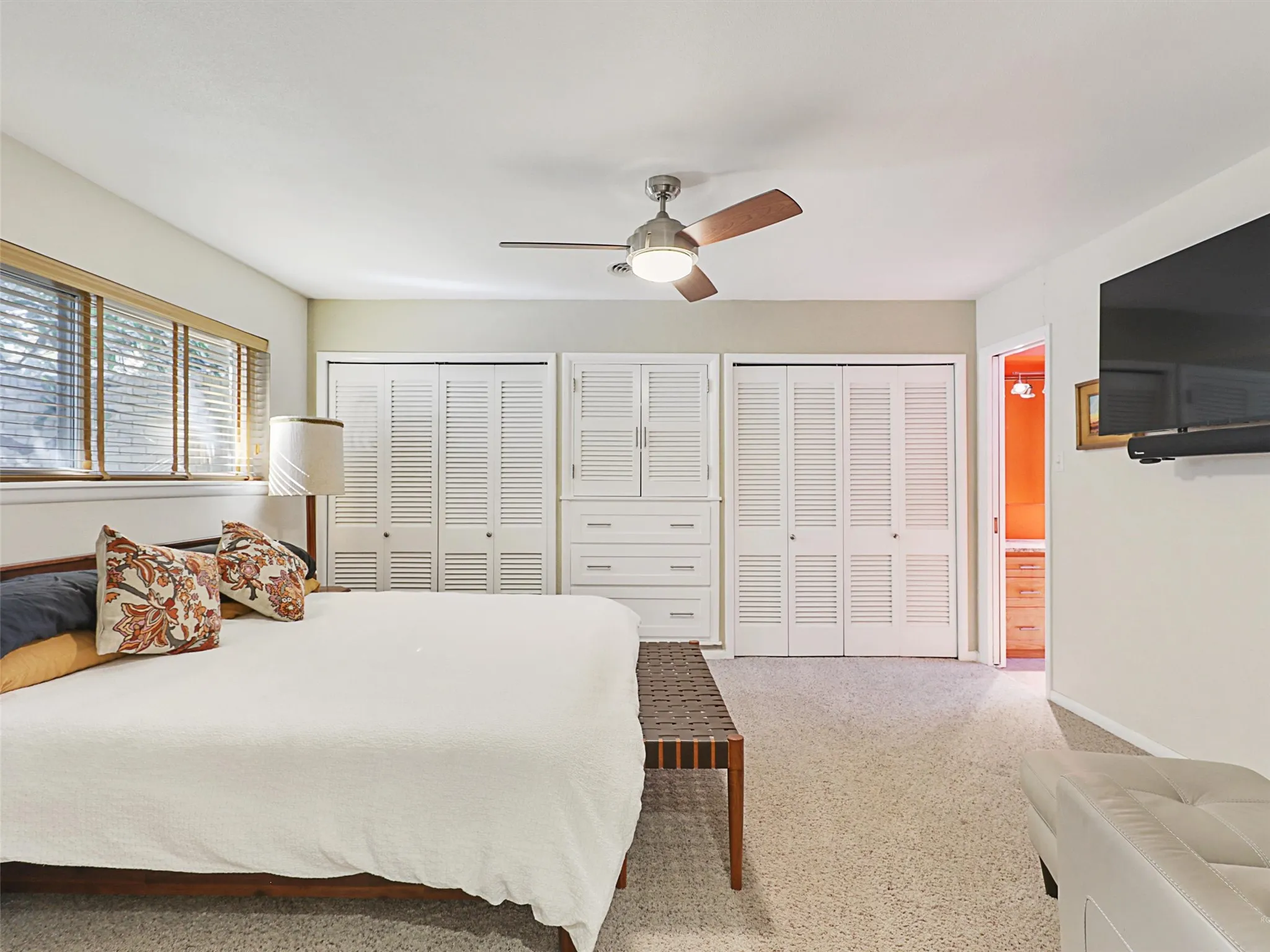 Spacious primary suite with sitting area and built-in storage