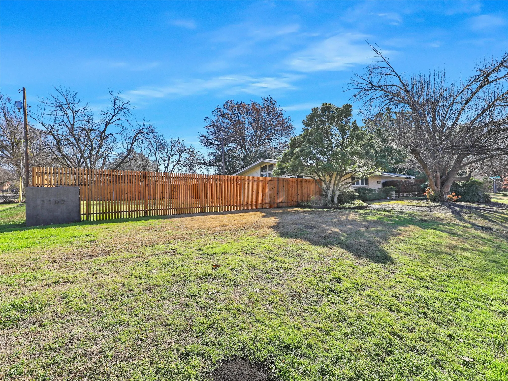 Wide exterior perspective highlighting lot size and setting