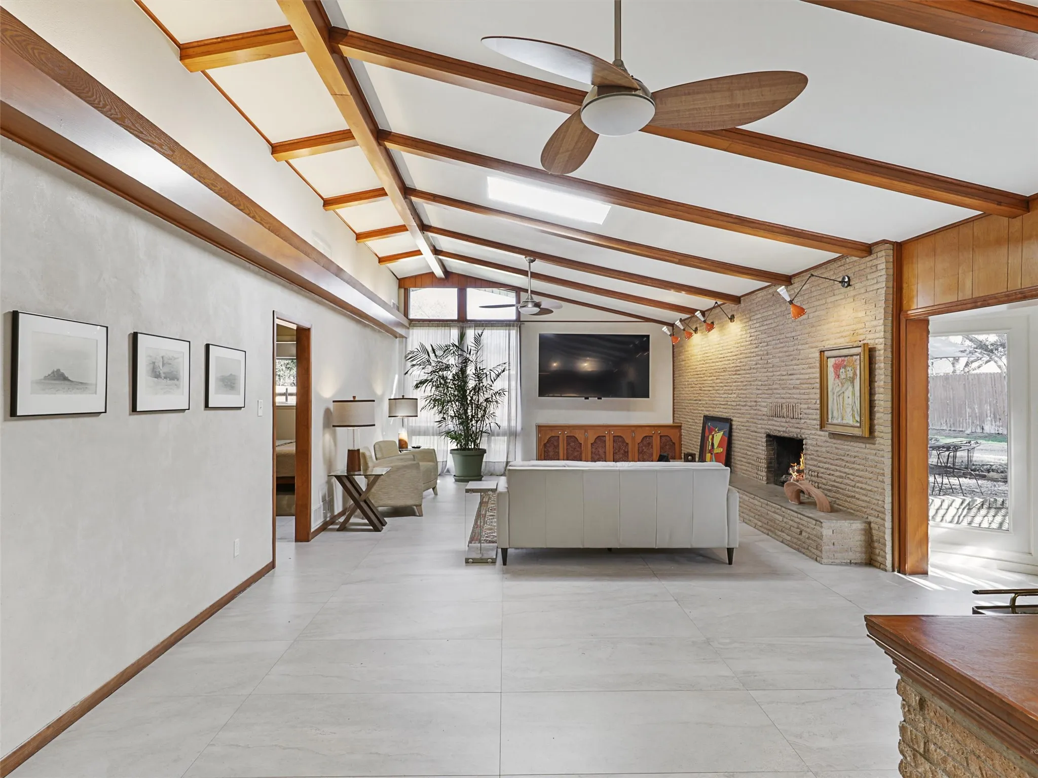 Light-filled living room with vaulted ceilings and expansive windows