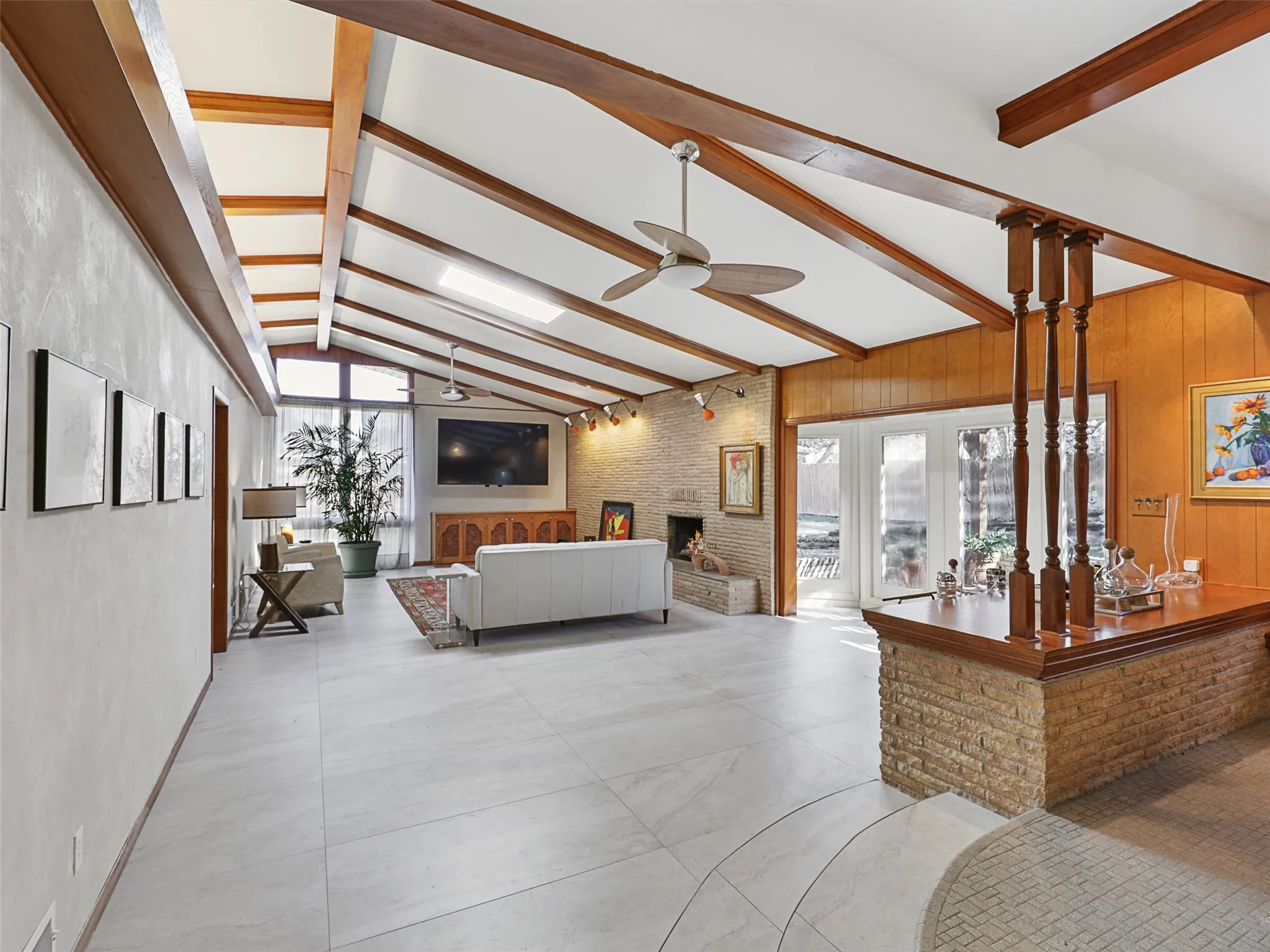 Open-concept living area featuring new tile flooring