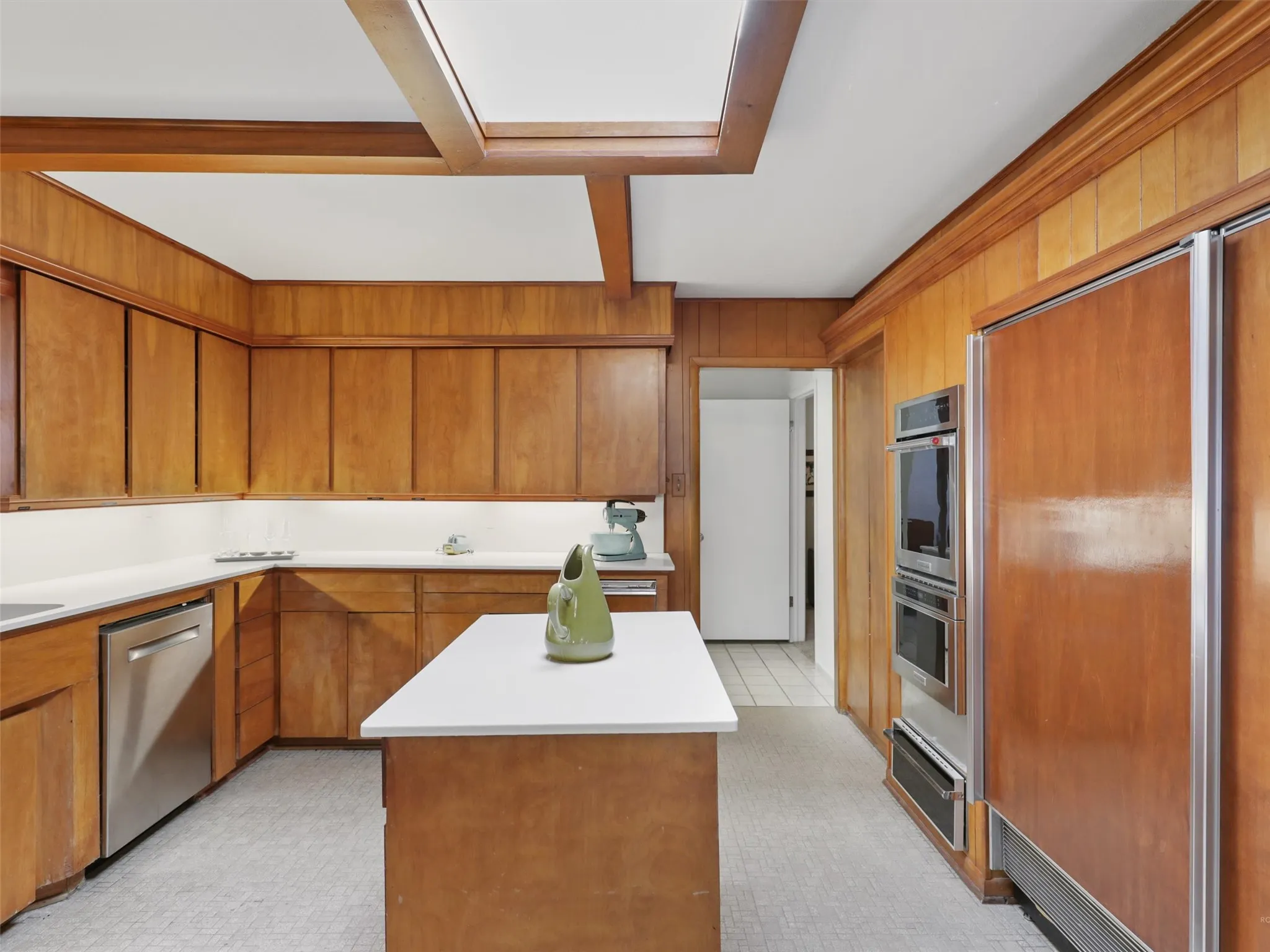 vintage kitchen with wood-paneled built-in SubZero refrigerator