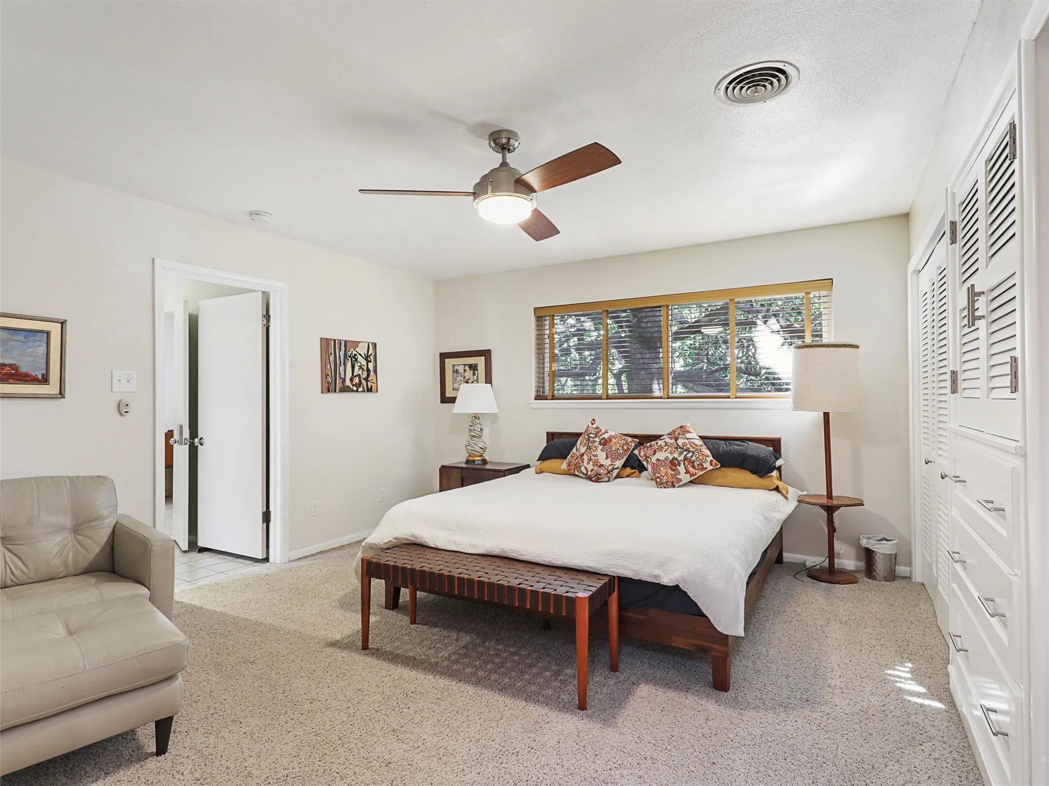 Peaceful primary bedroom retreat with natural light