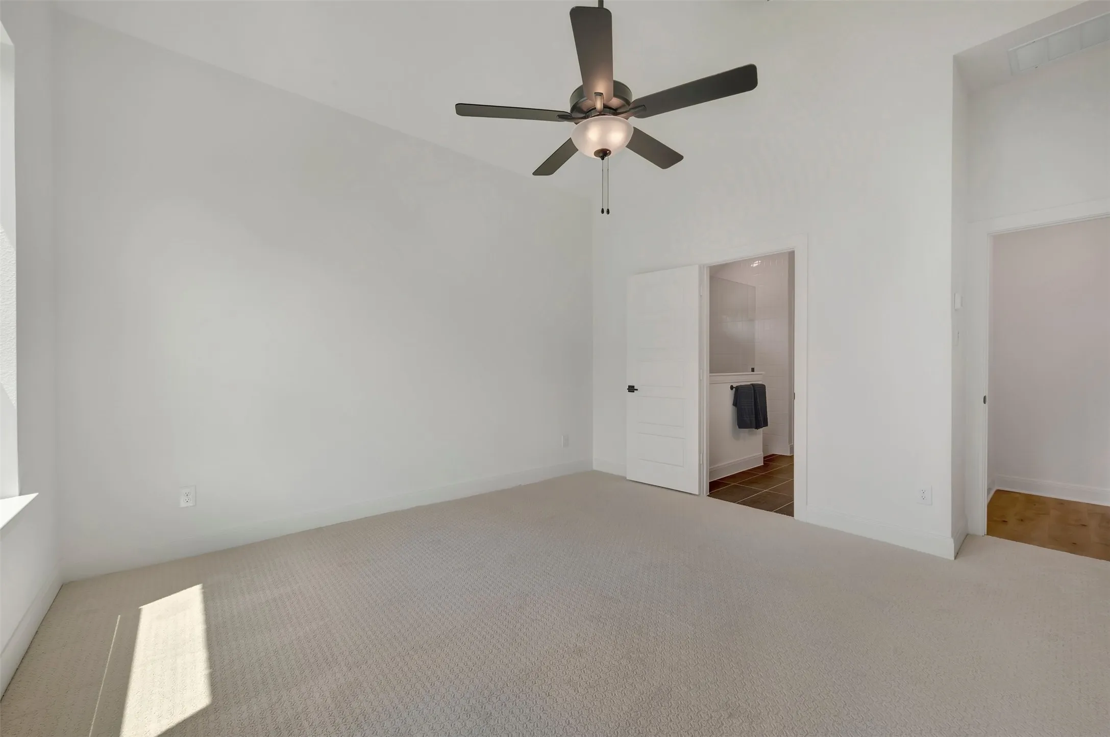 Vaulted ceilings featuring a ceiling fan with integrated lighting