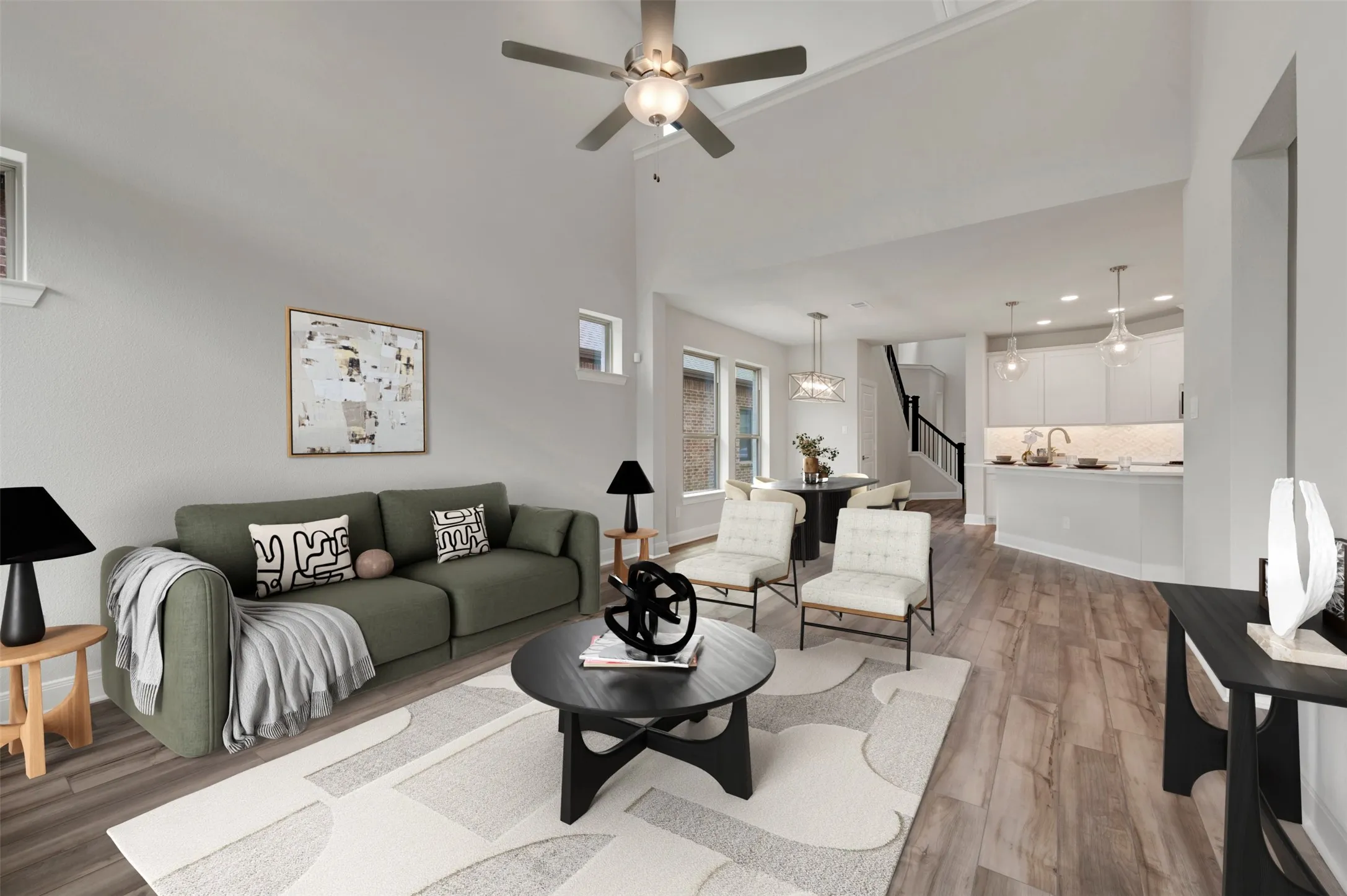Open-concept living space featuring wood-finish flooring, a vaulted ceiling with a ceiling fan, and recessed lighting