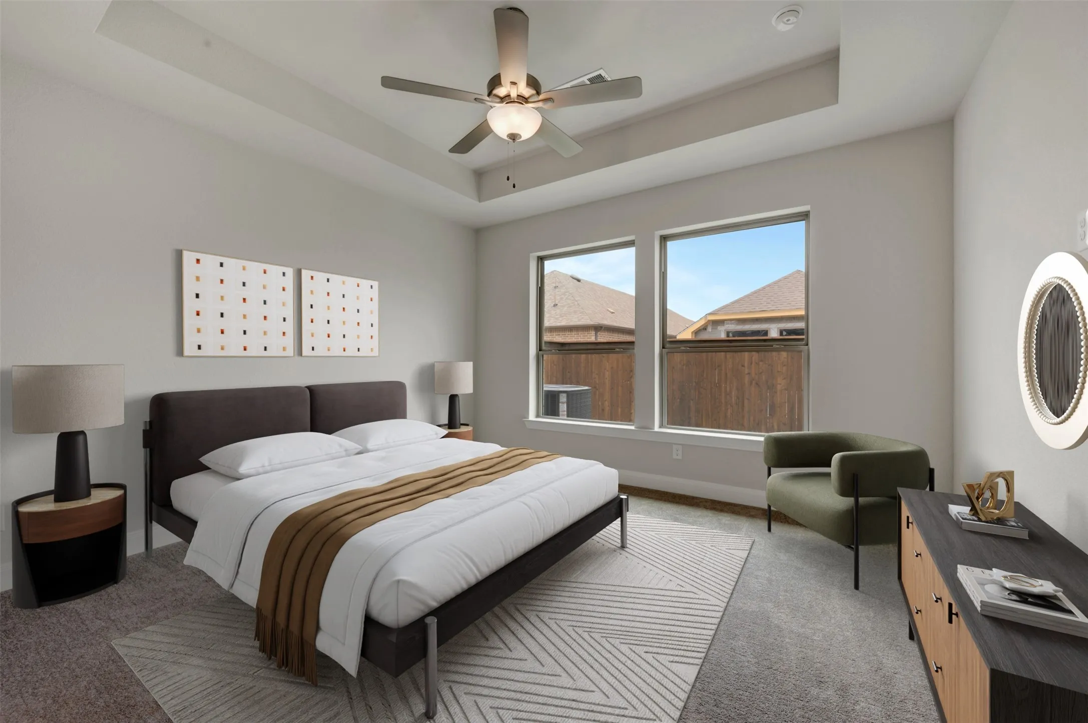 Spacious room featuring a tray ceiling with a ceiling fan, two windows, and carpeting