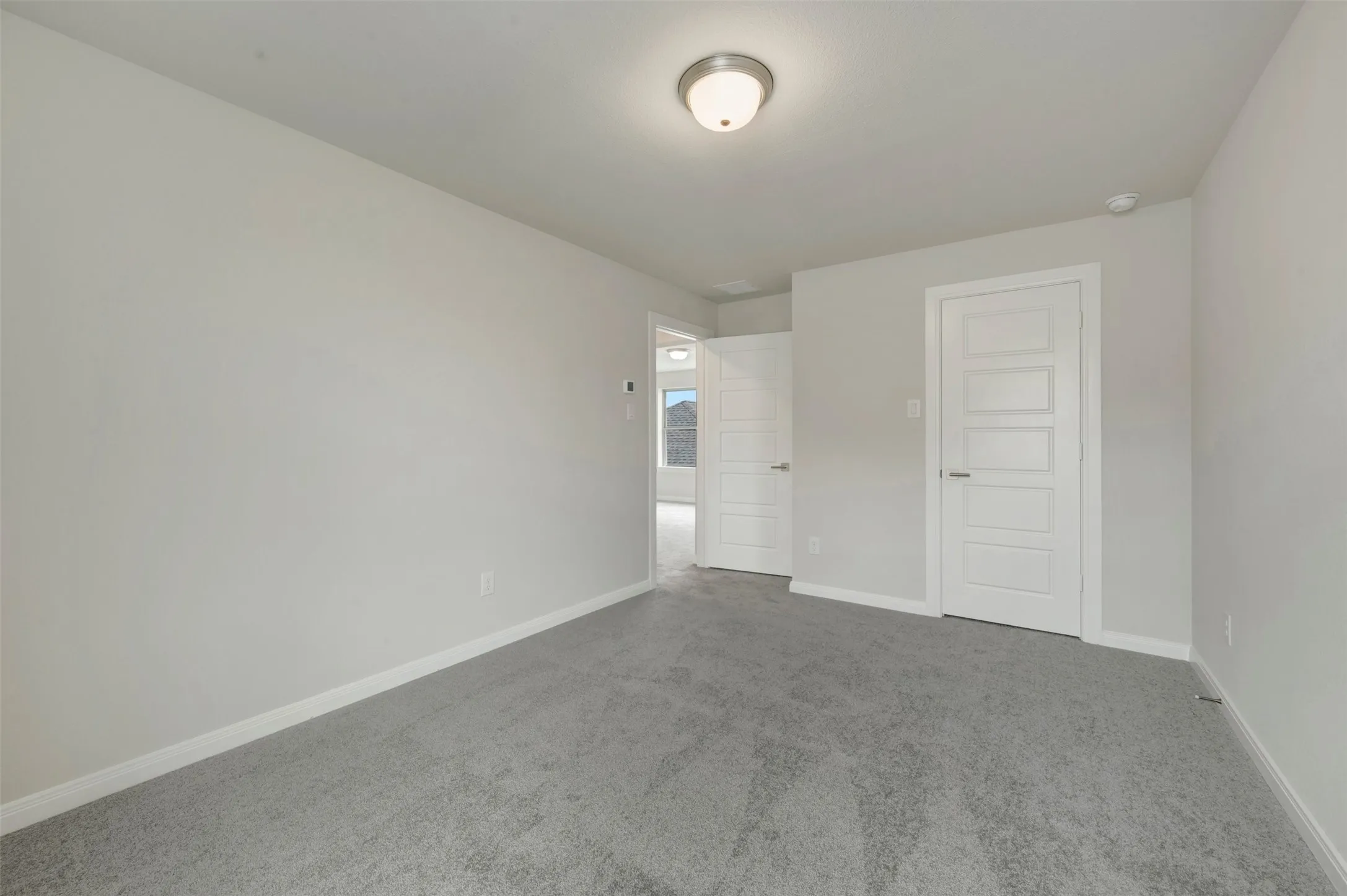Neutral gray carpet flooring complementing light-toned walls
