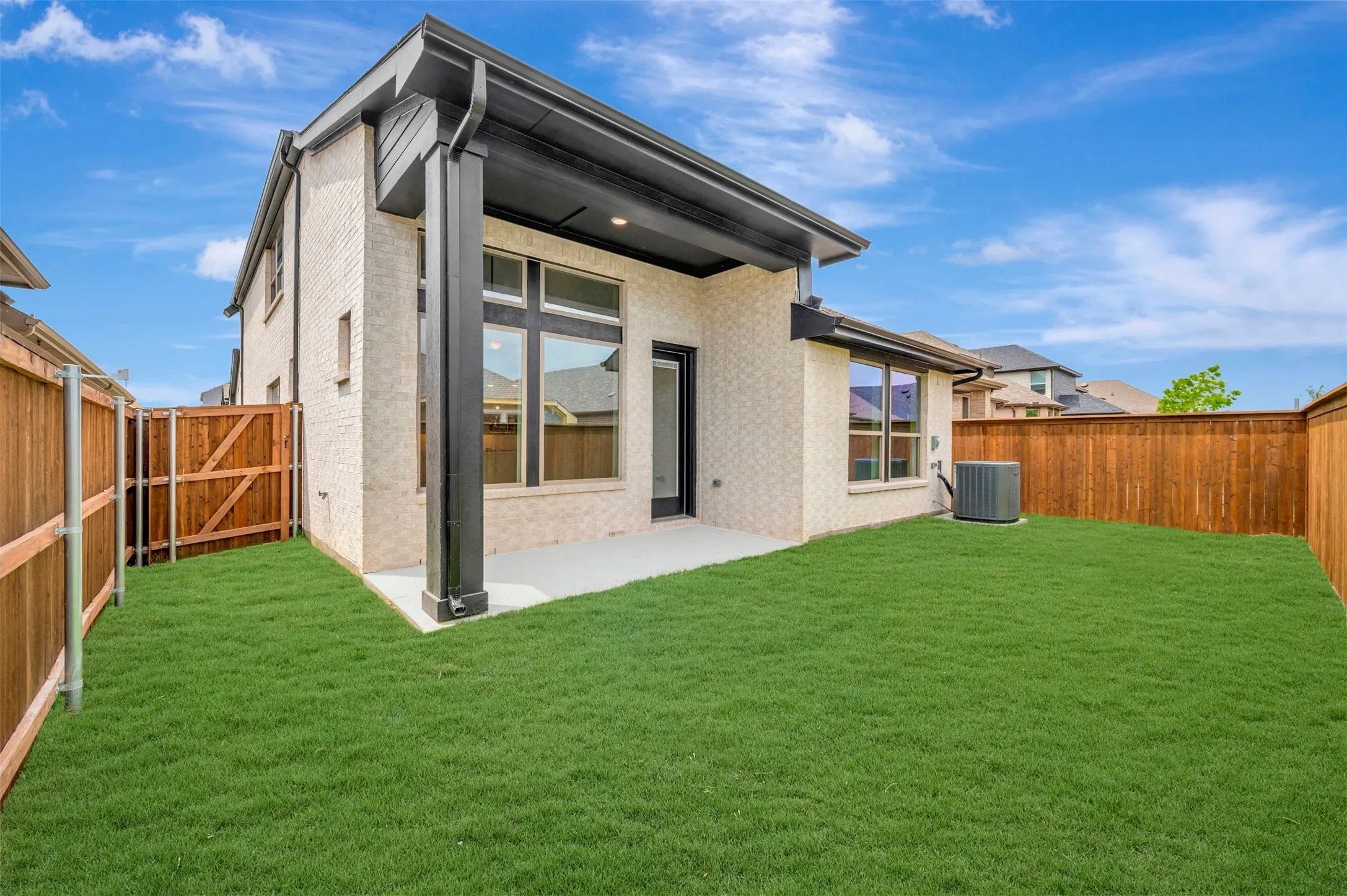 Private backyard with a manicured lawn