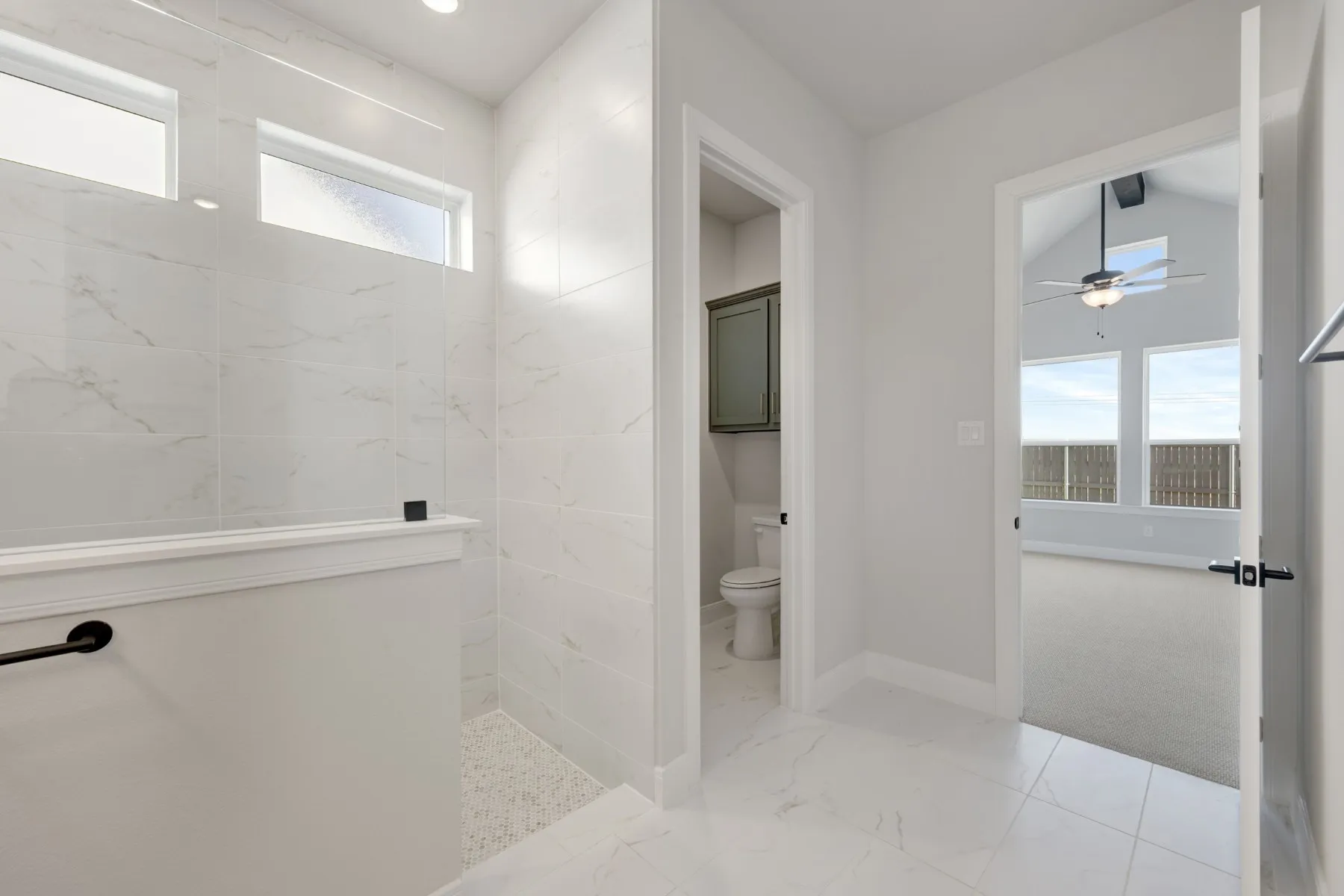 Full bathroom with a walk in shower, light marble finish floors, and a ceiling fan