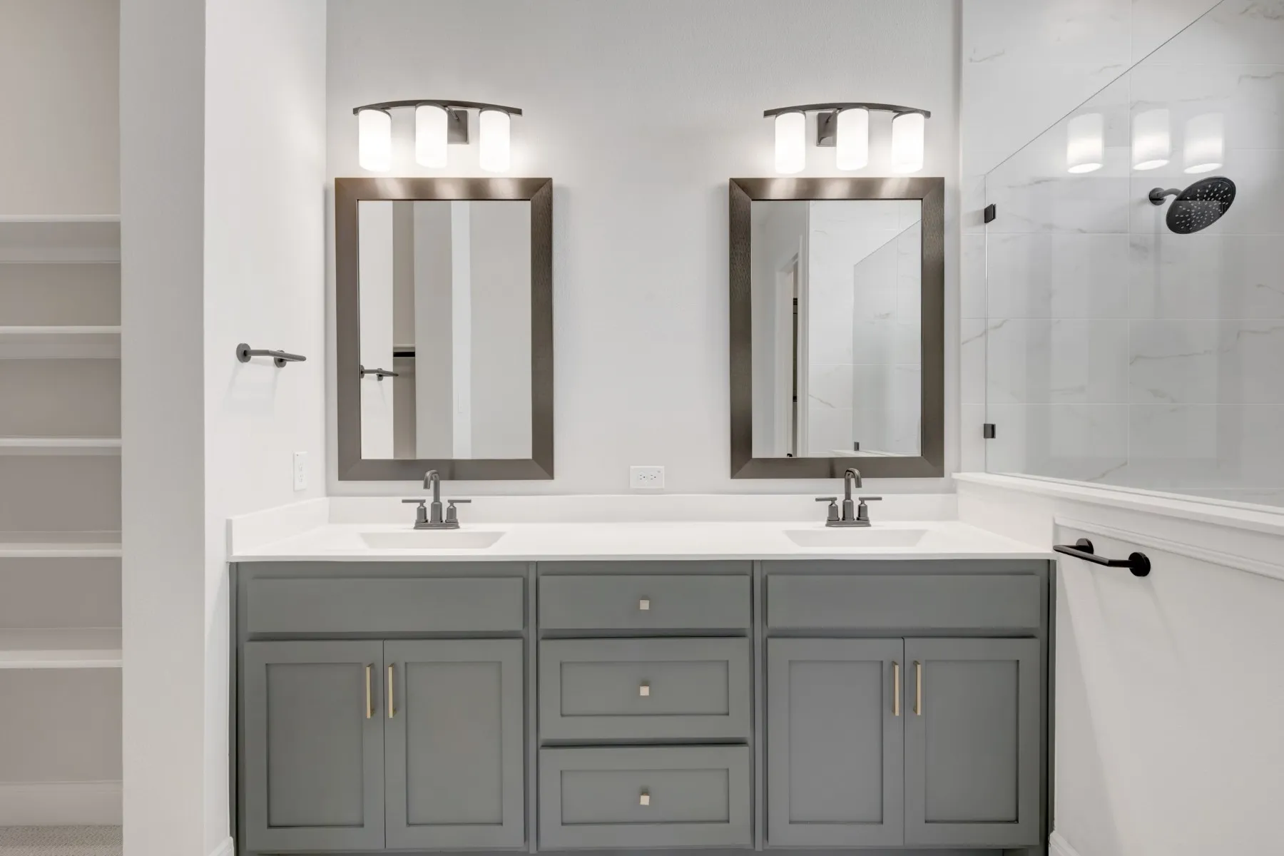 Bathroom with double vanity and a tile shower
