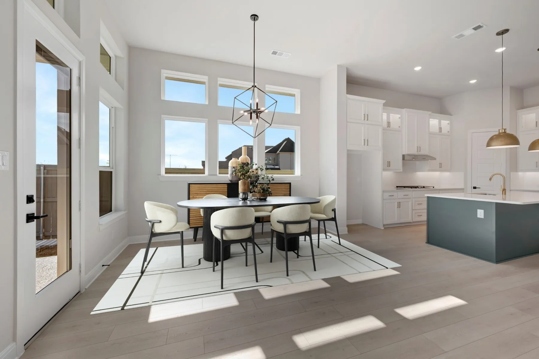 Dining space featuring healthy amount of natural light, light wood-style floors, and hanging lights