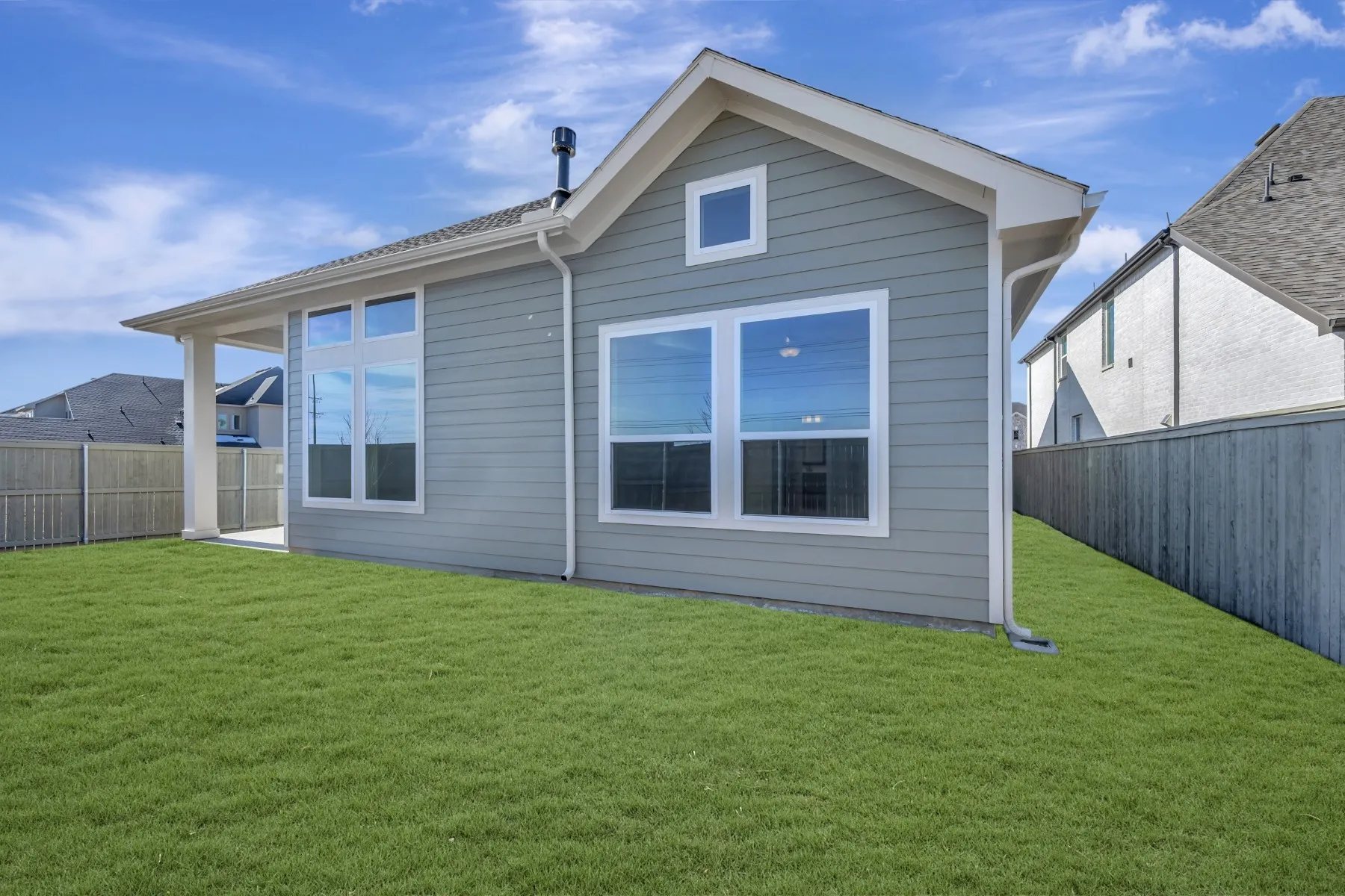 Back of property with a fenced backyard and a patio