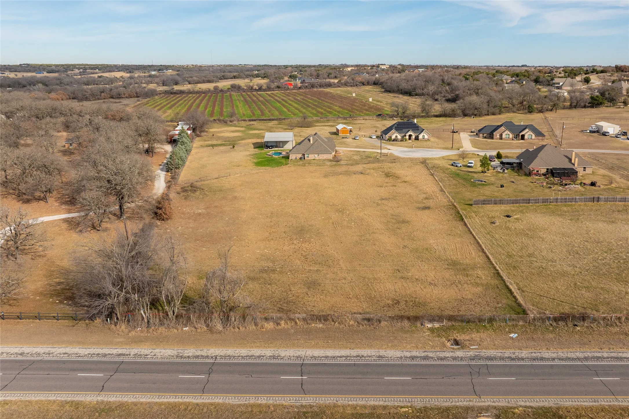 Overview of rural landscape featuring large plots for crops