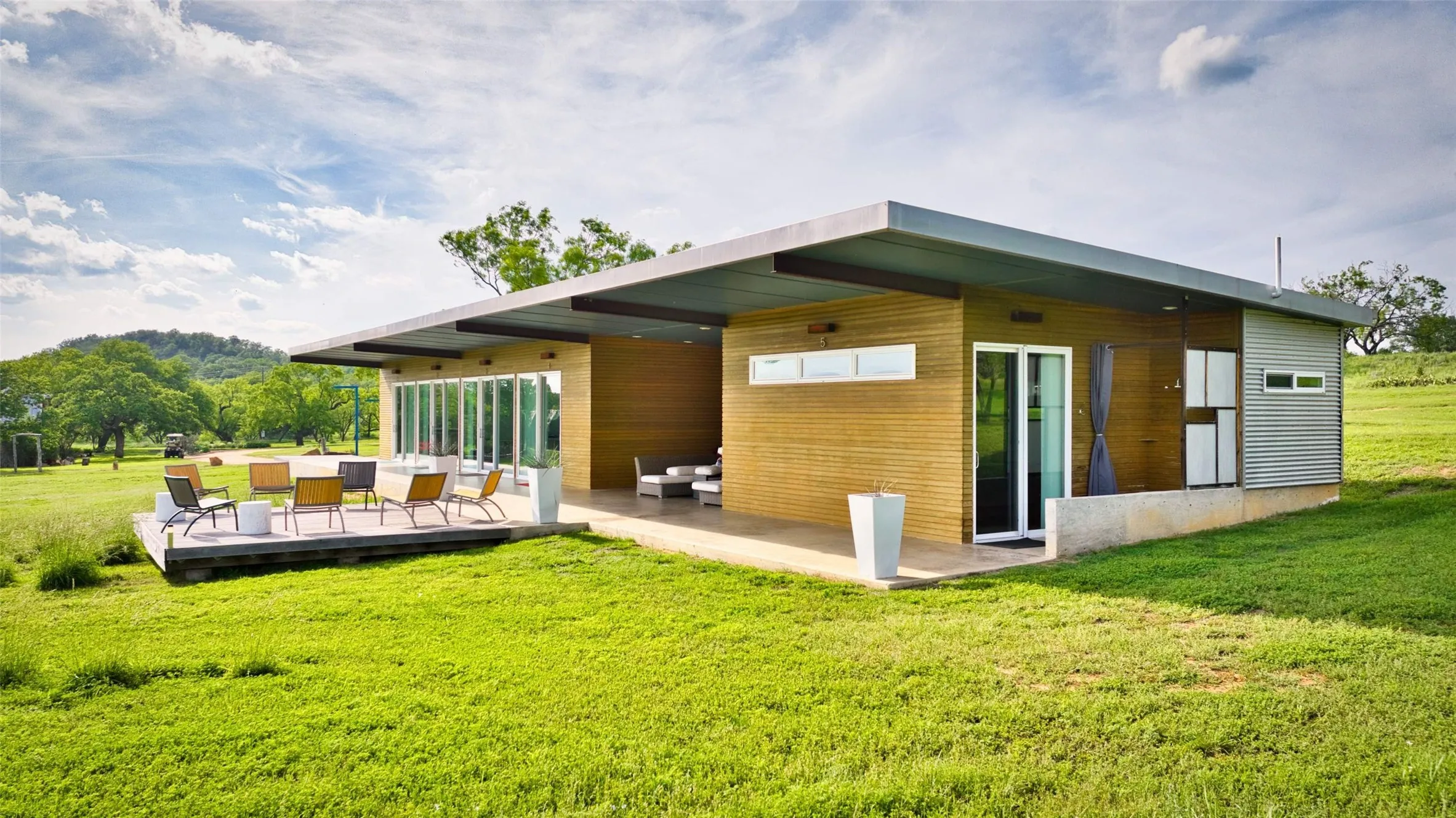 Modern single-story residence featuring a flat roofline and extensive outdoor living spaces