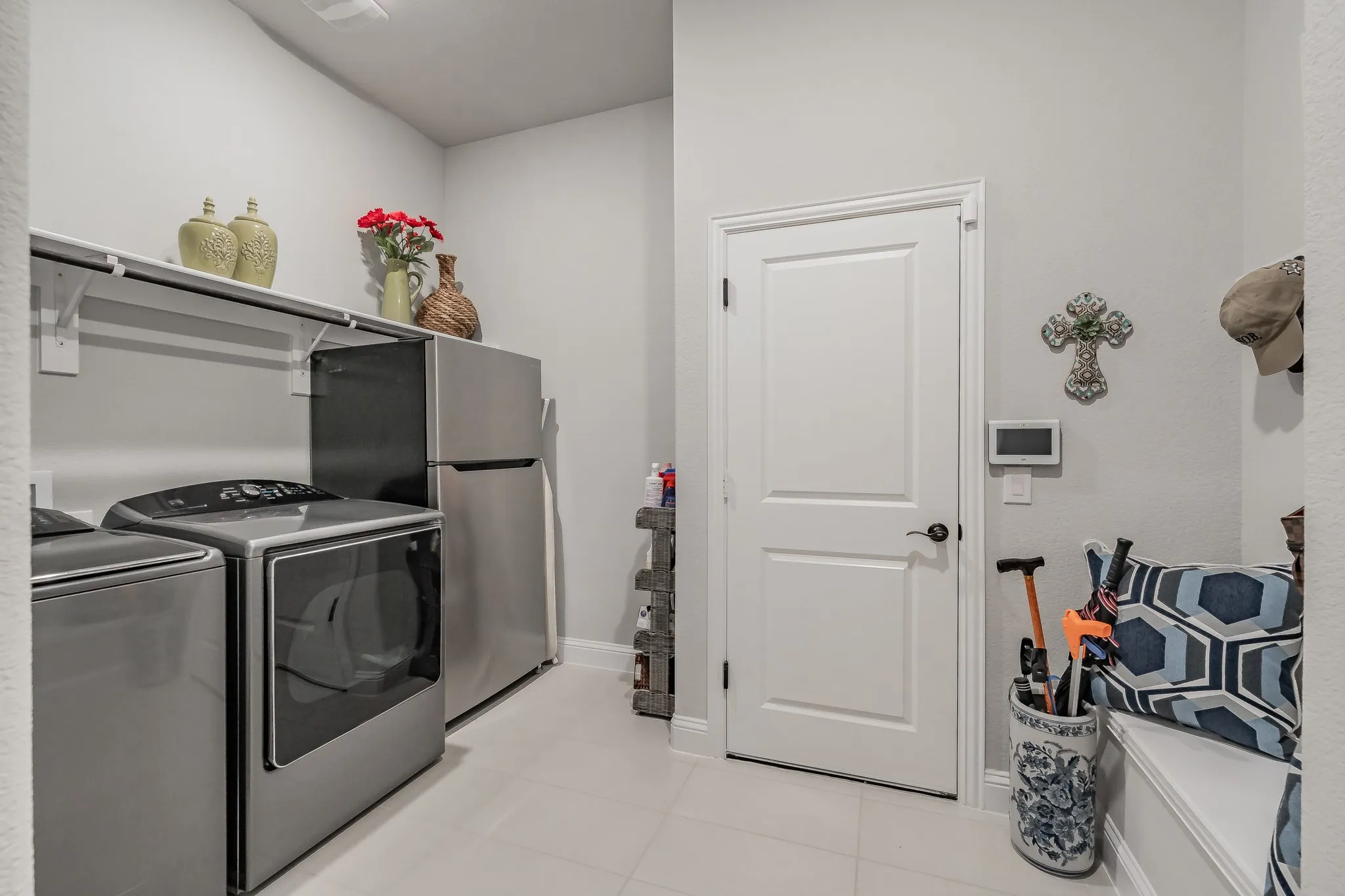 Great sized laundry room with room for a fridge, hang dry area and mudroom area.  It also opens to the primary bedroom closet for ease of access.