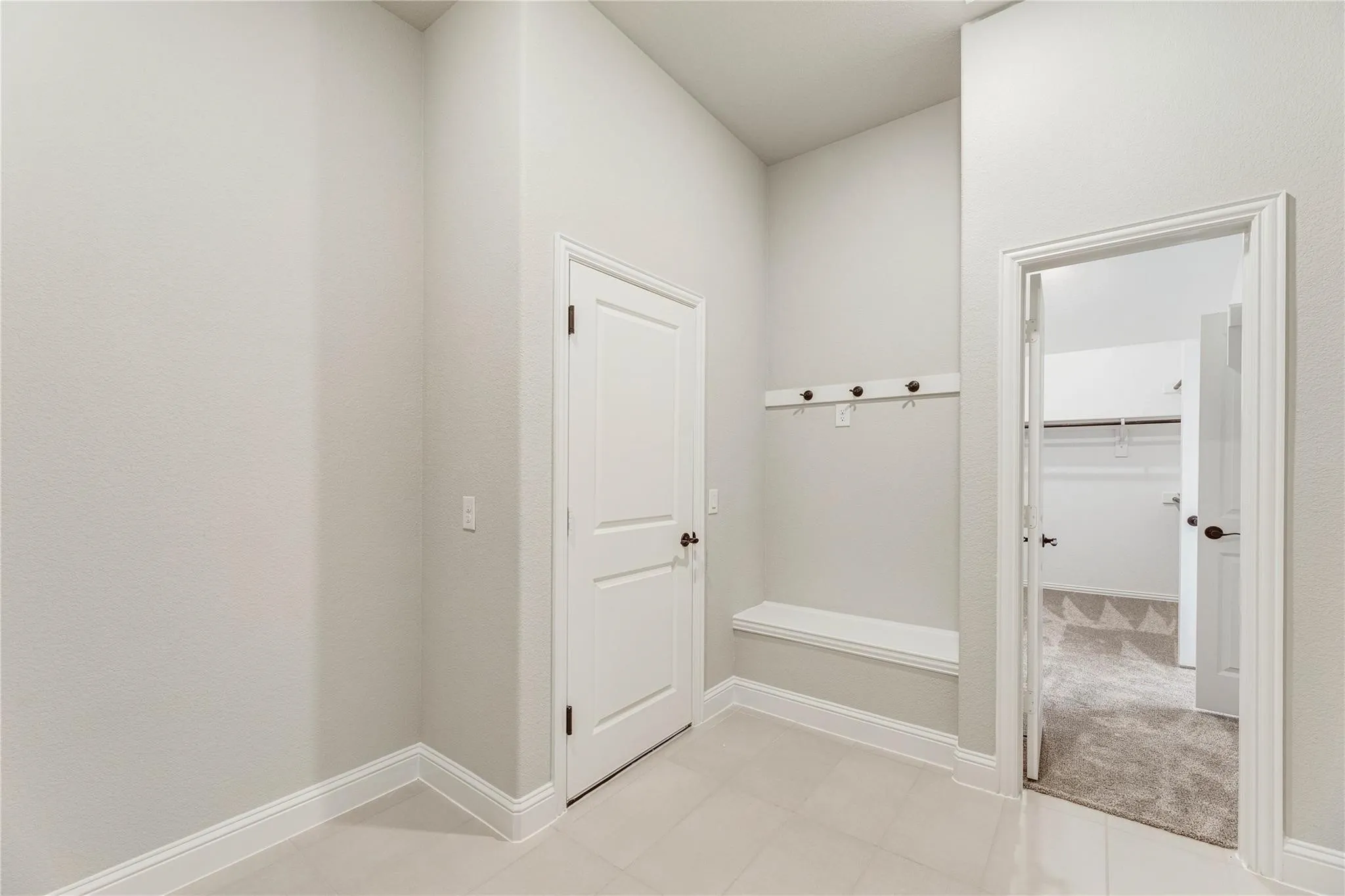 Builder photo showing the mudroom and ease of access to the primary closet.