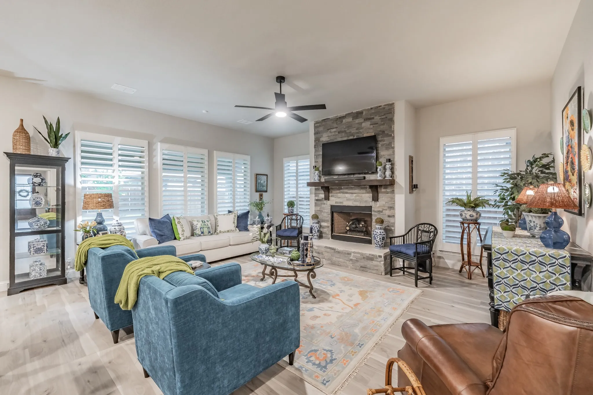 The beautiful living room has a floor to ceiling fireplace with gas starter.  Overlooks the backyard