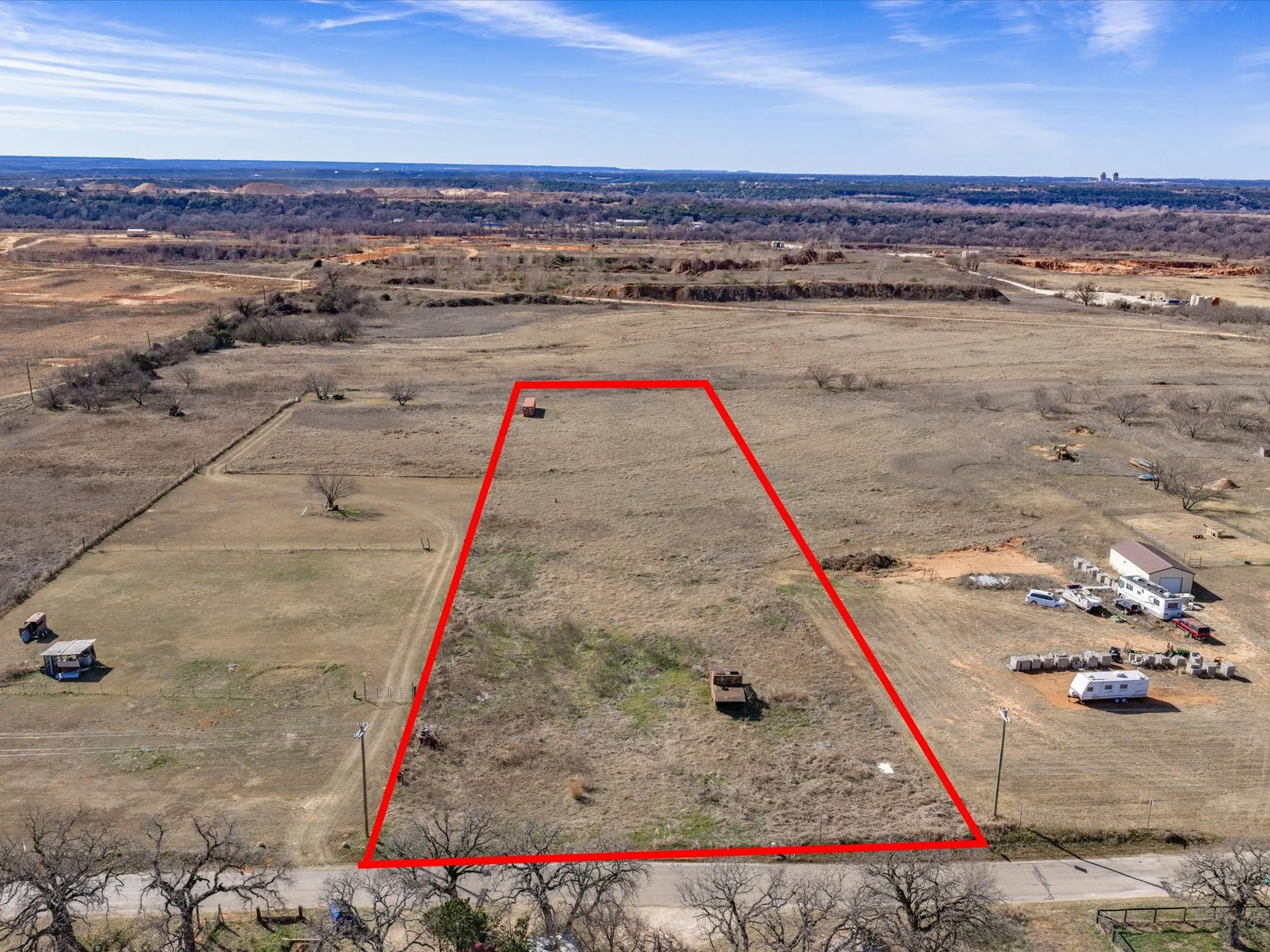 Aerial view of sparsely populated area featuring property parcel outlined and a desert landscape