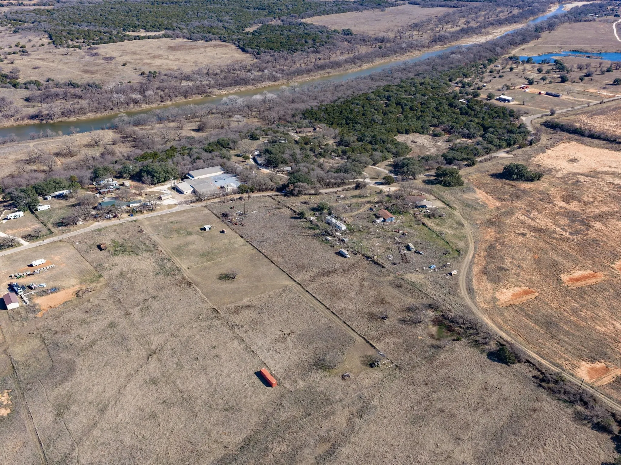 Aerial view of property's location with a nearby body of water and rural landscape