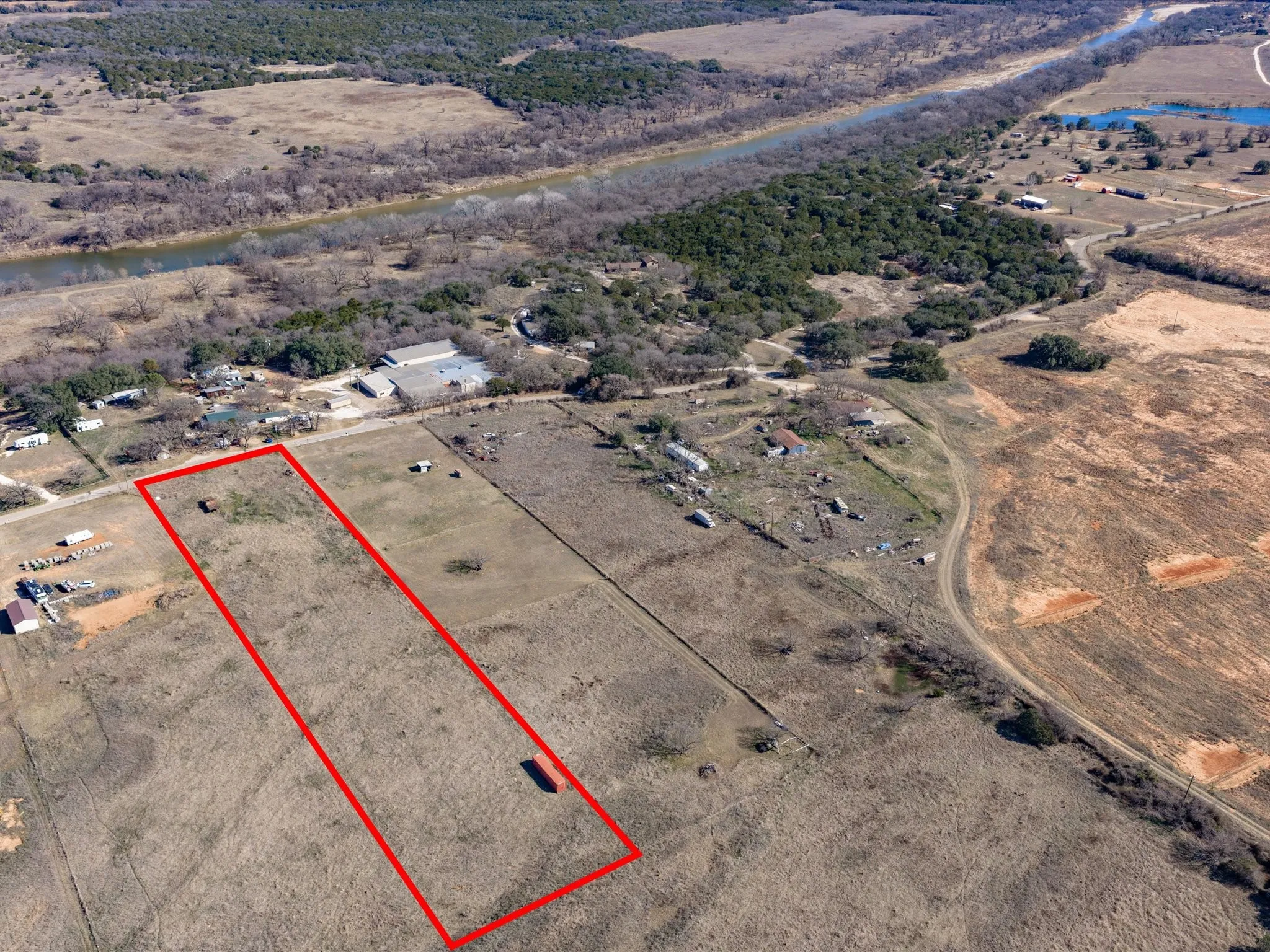 Aerial view of sparsely populated area featuring property parcel outlined and a desert landscape