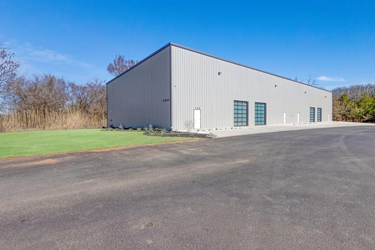 View of building exterior with a garage and an outbuilding