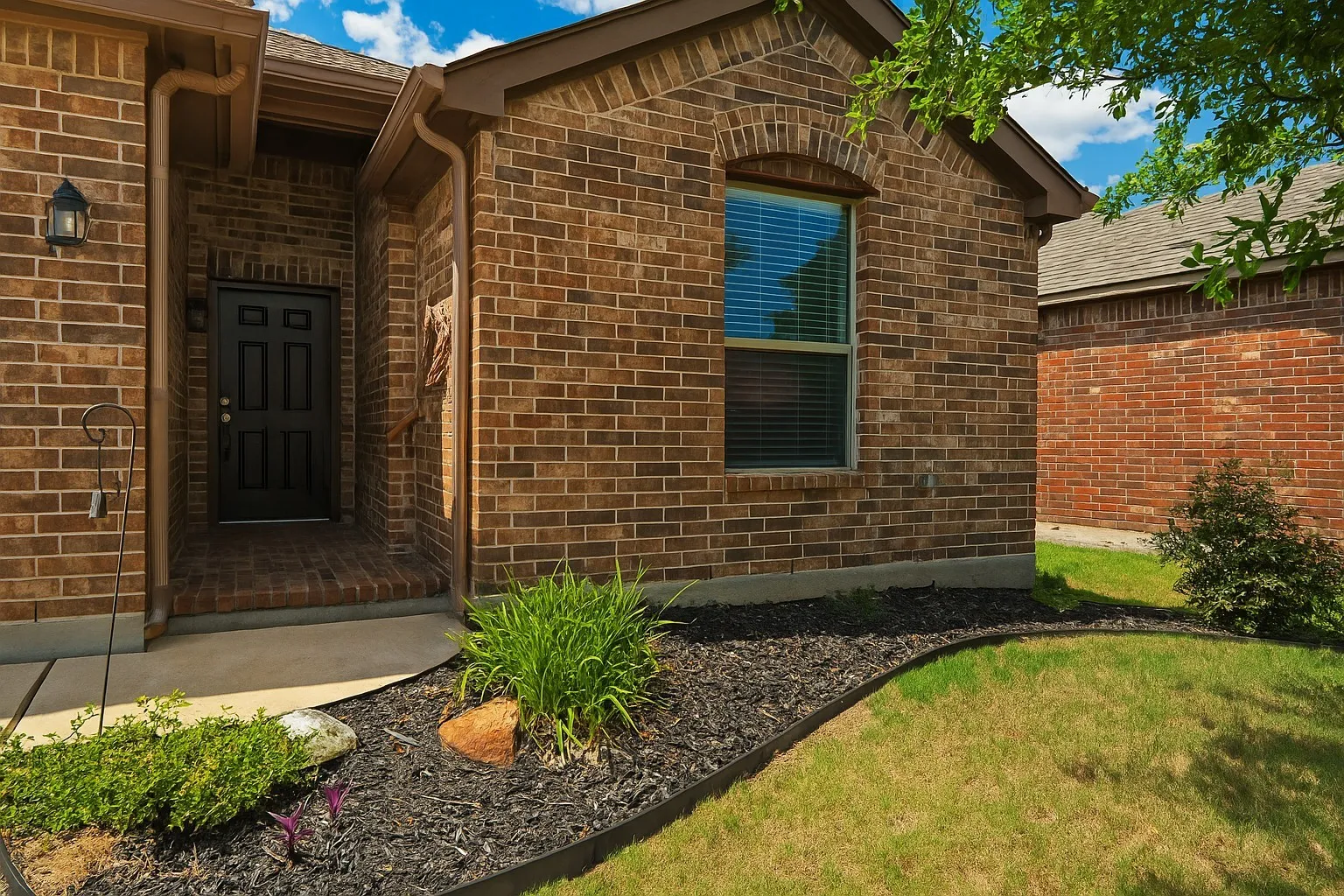 View of exterior entry with brick siding