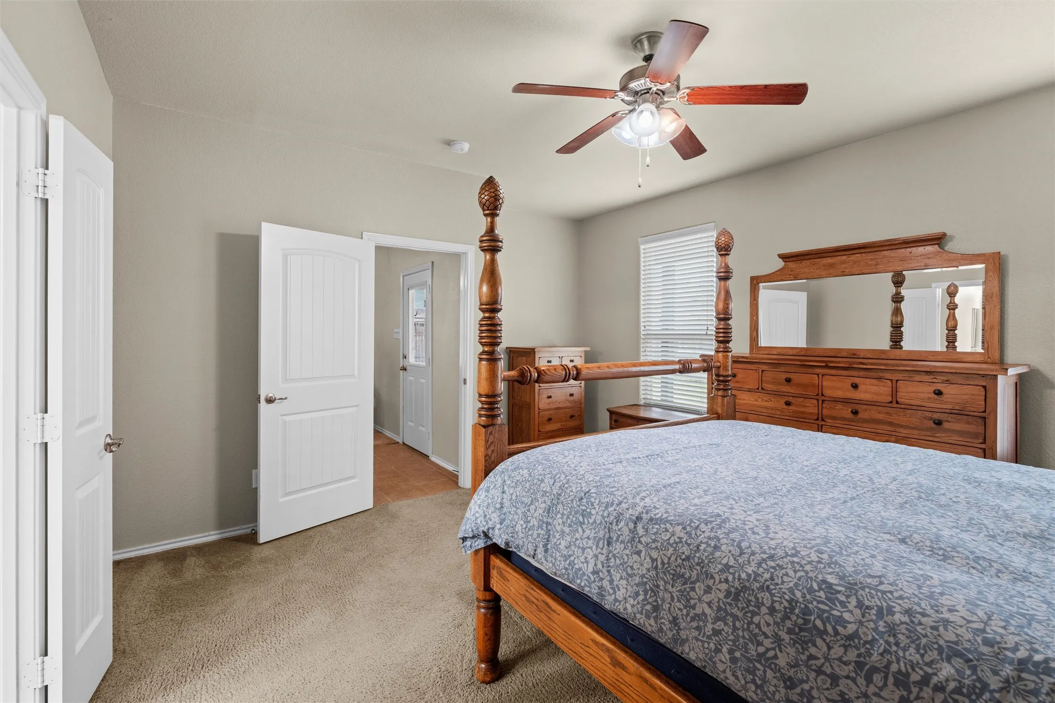 Bedroom featuring light colored carpet and a ceiling fan
