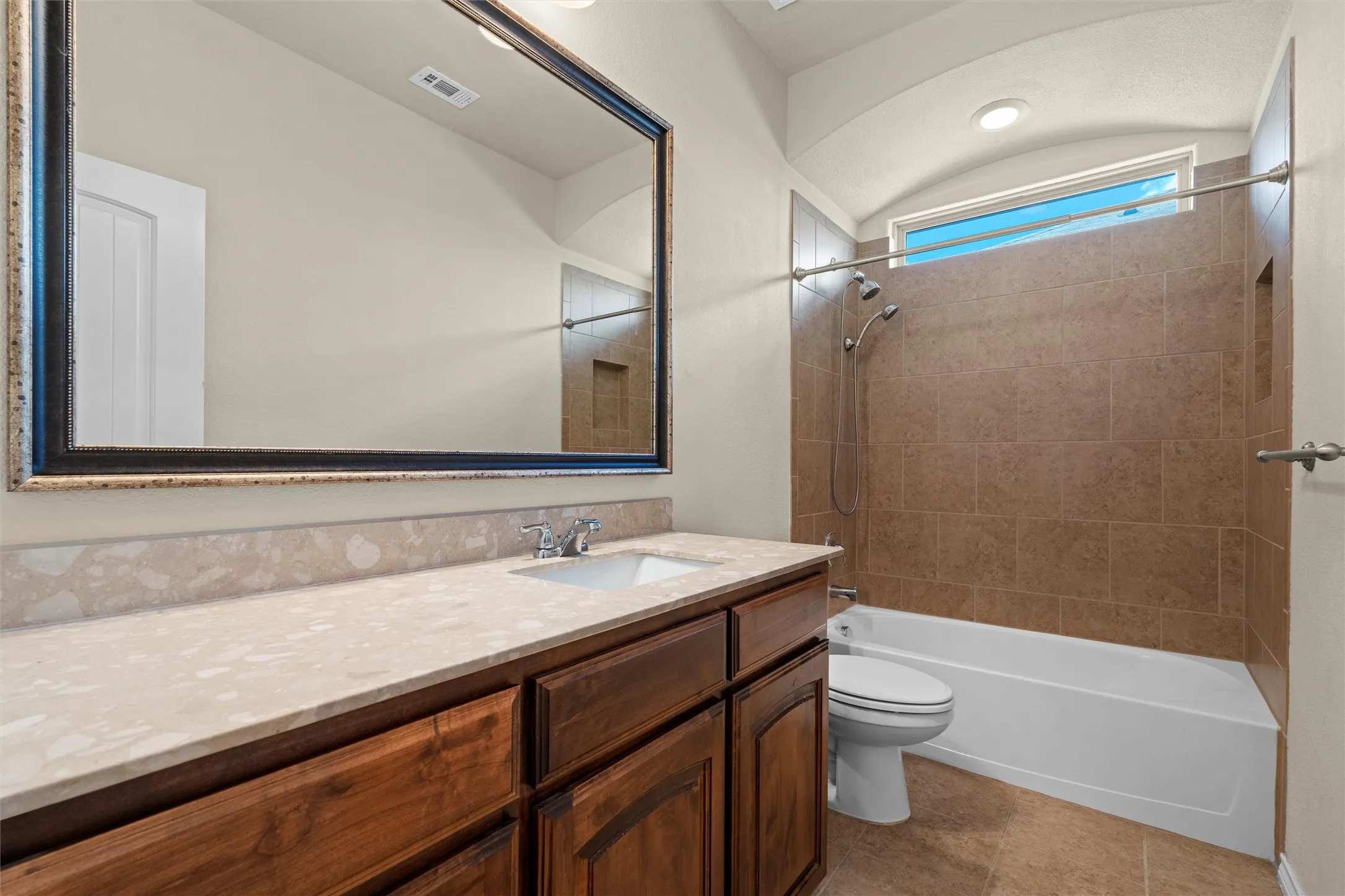 Full bath with vanity, shower / bathtub combination, and light tile patterned flooring