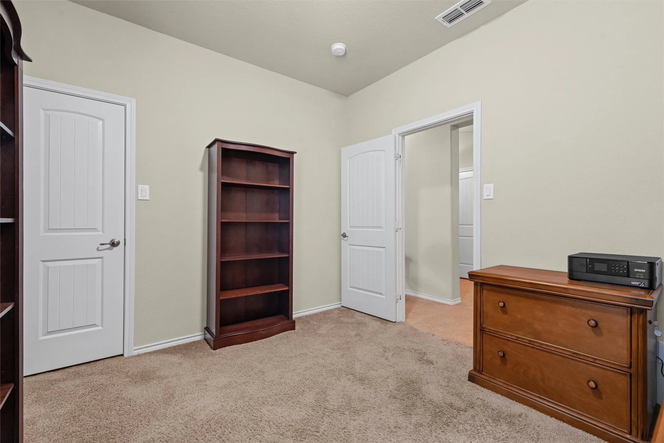 Bedroom featuring light colored carpet and baseboards