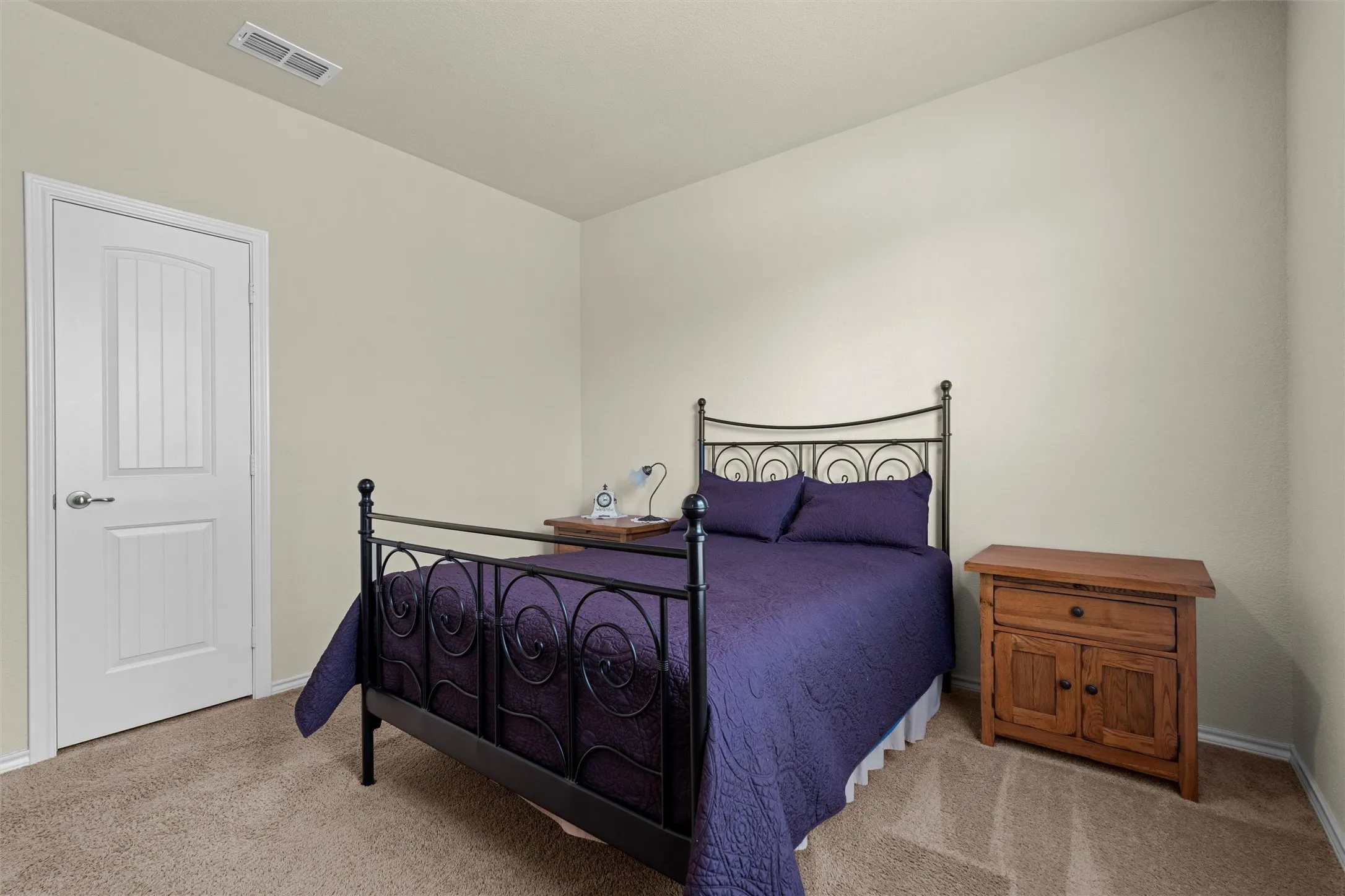 Carpeted bedroom with baseboards