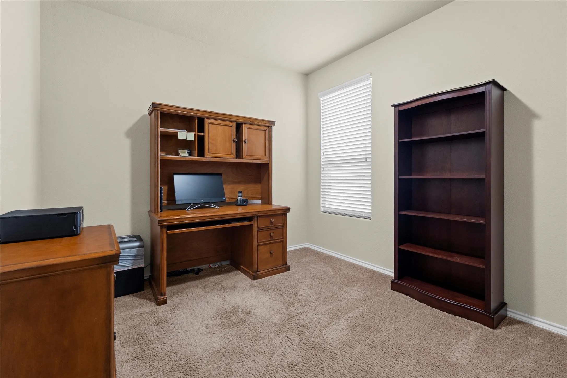 Office space featuring light carpet and baseboards
