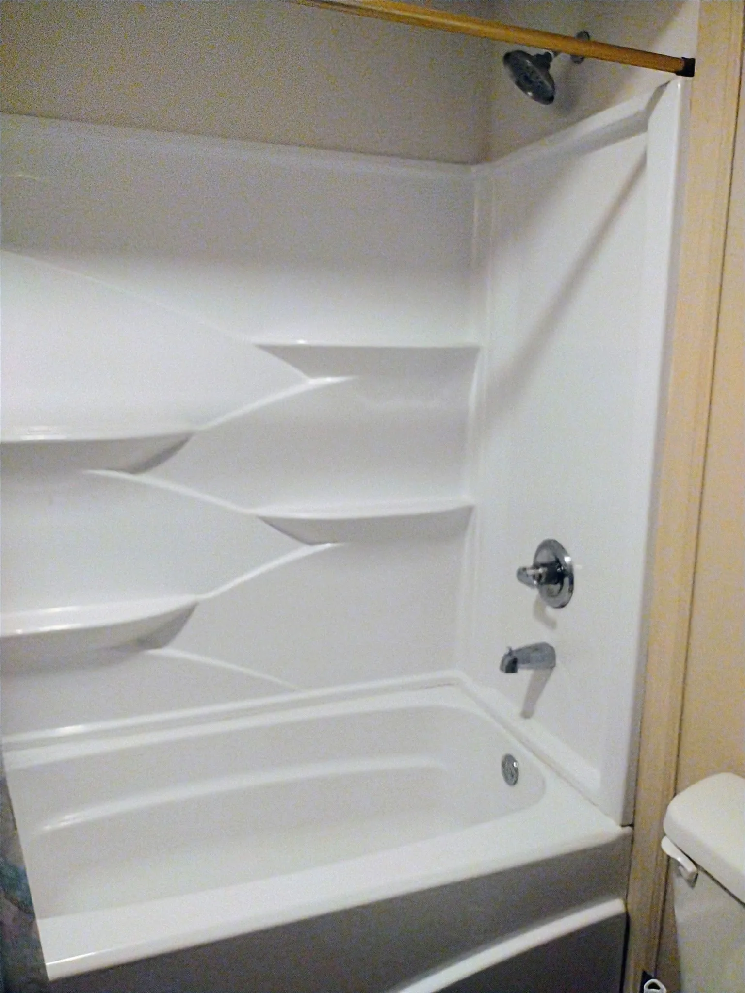 Full bath featuring shower / tub combo and toilet