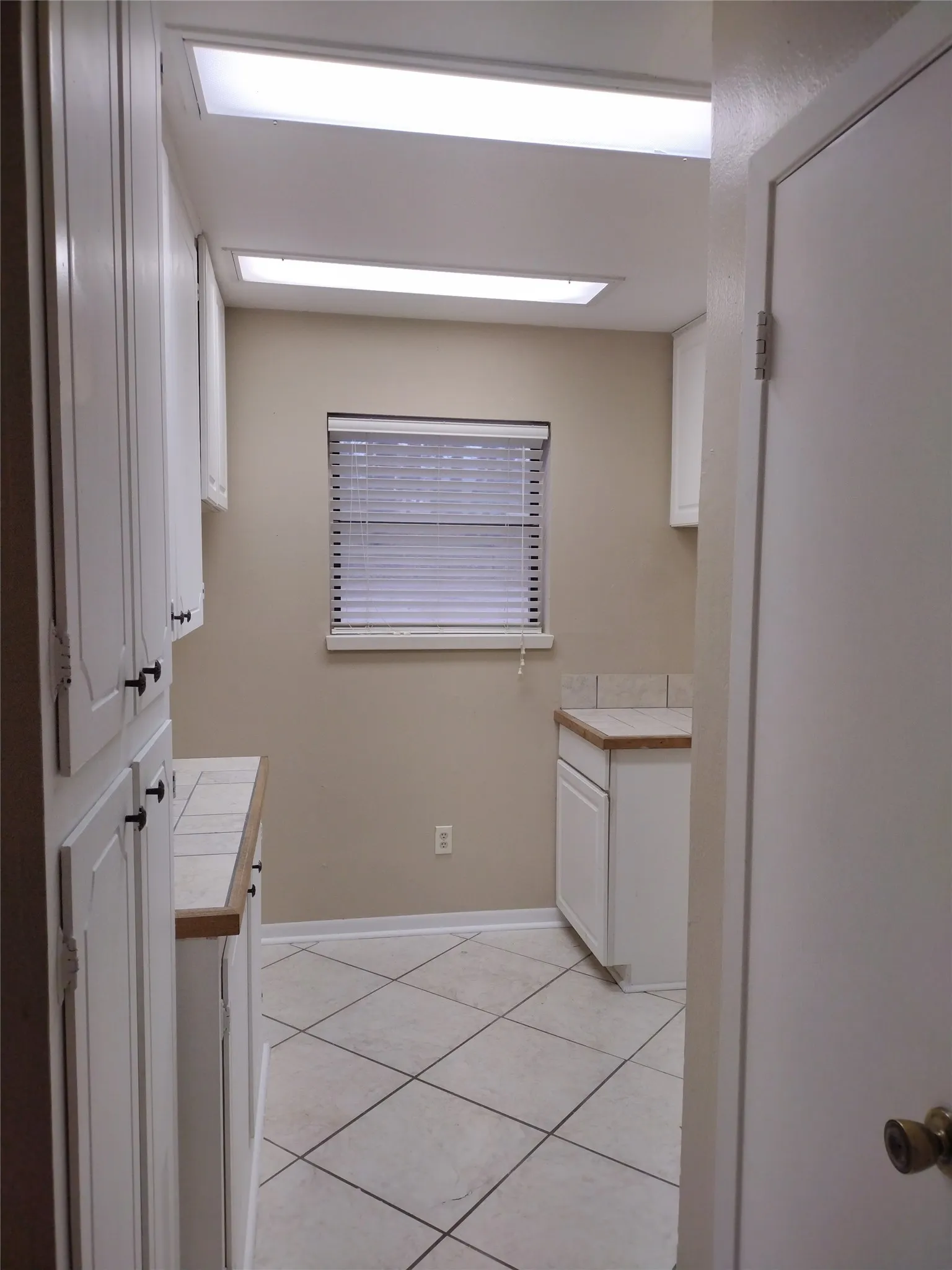 Laundry and Pantry with ample storage and half bathroom