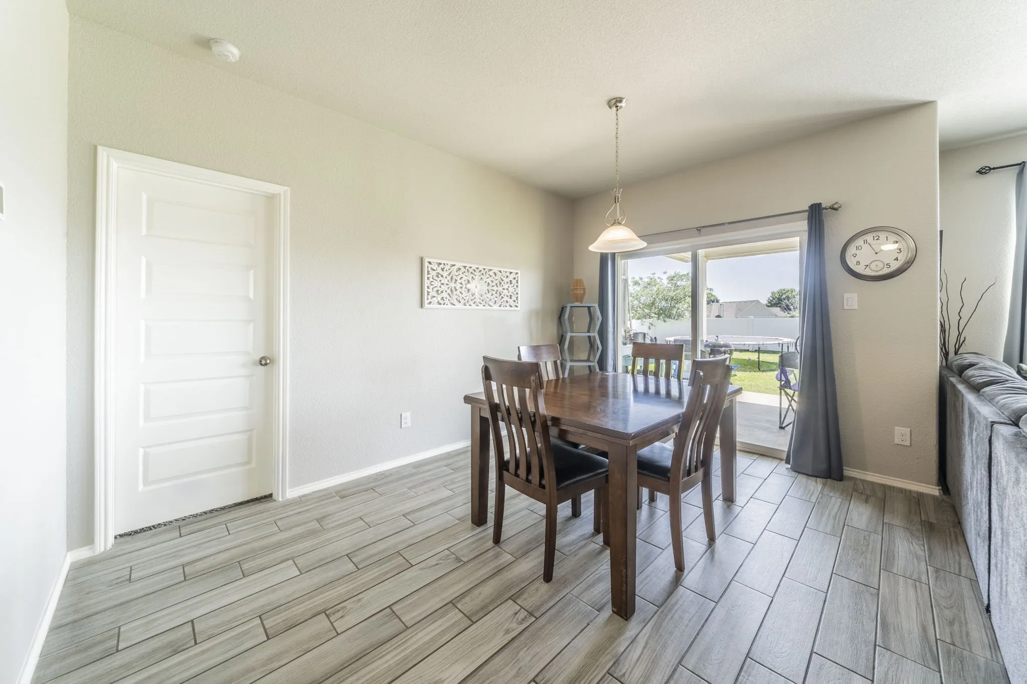 Dining space with wood tiled floors