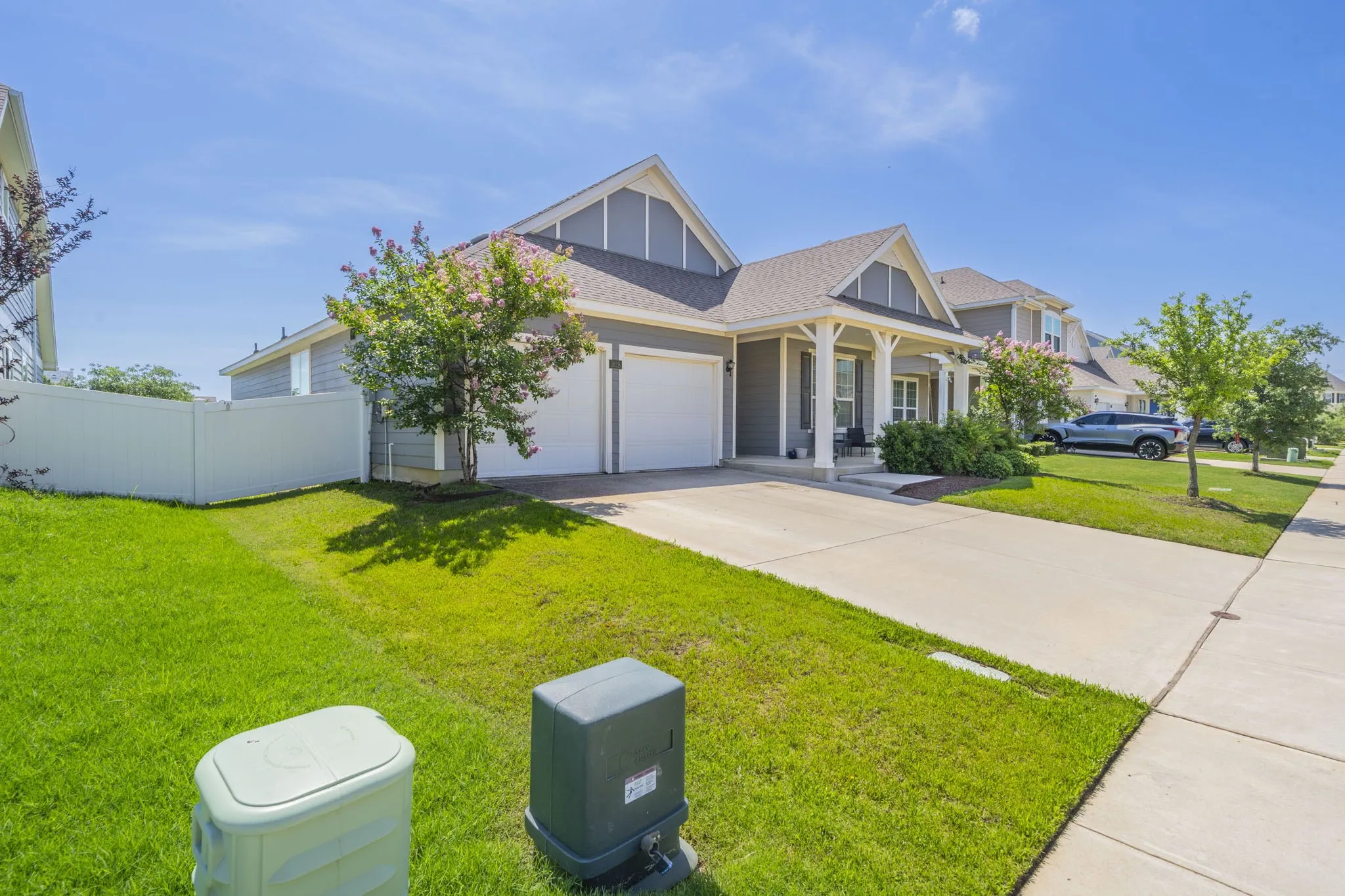 Craftsman inspired home featuring covered porch, driveway, a garage, and a shingled roof