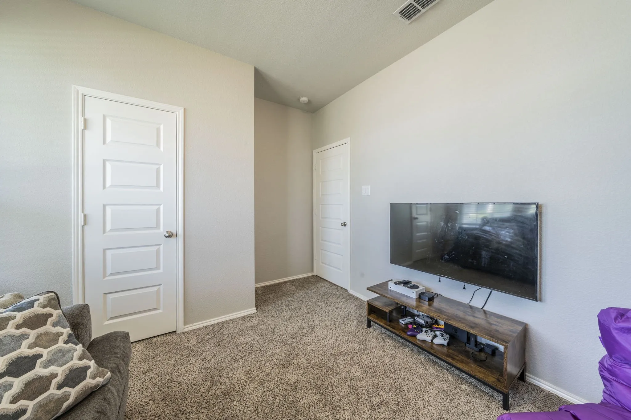 Carpeted living area with baseboards