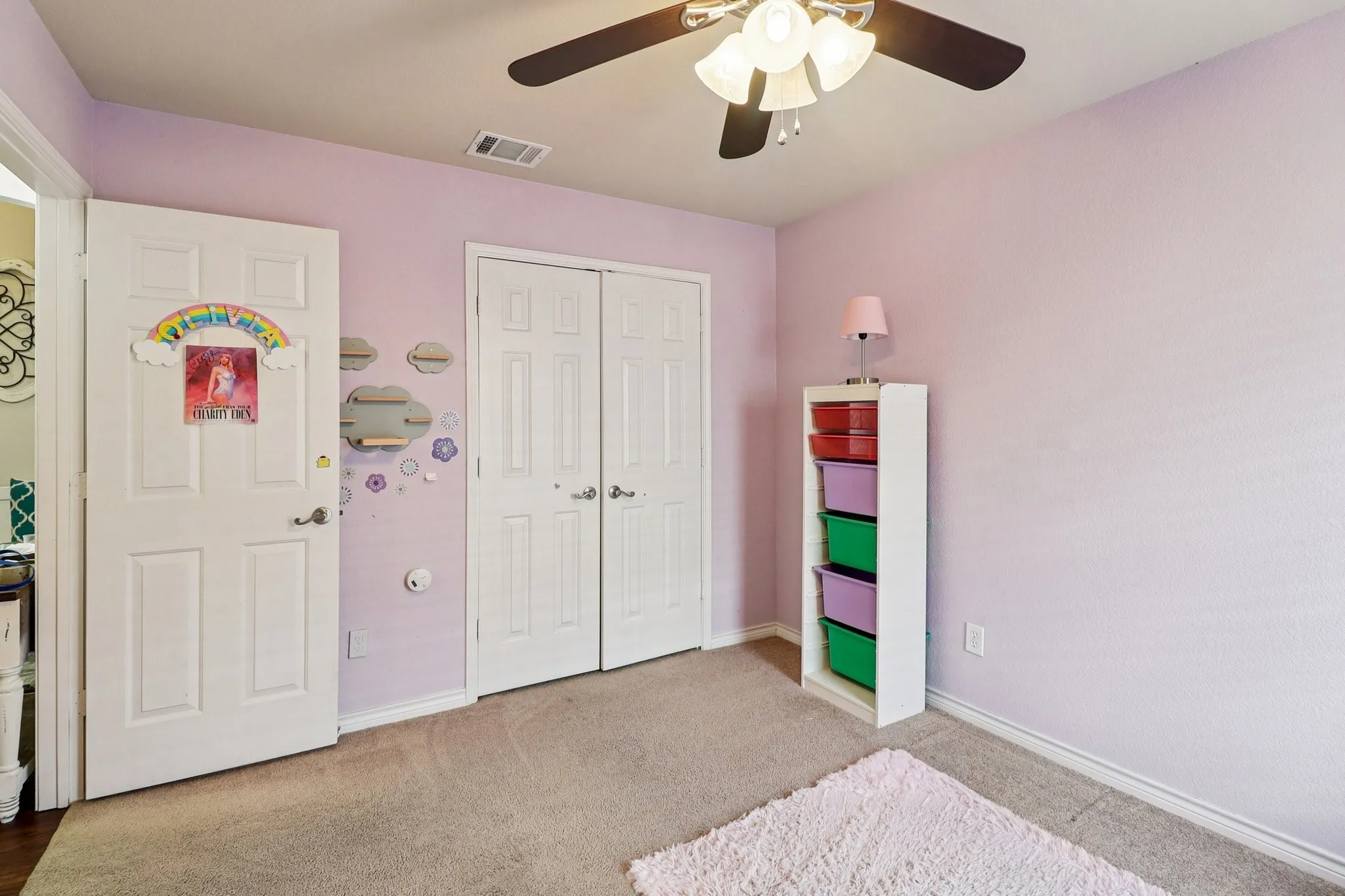 Bedroom with carpet floors, ceiling fan, and a closet