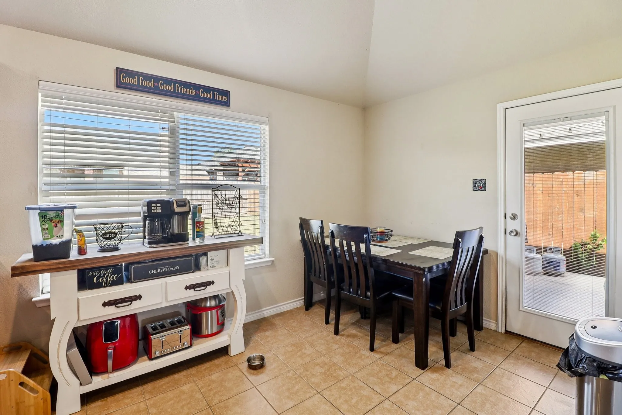 Dining room with plenty of natural light, lofted ceiling, and light tile patterned floors