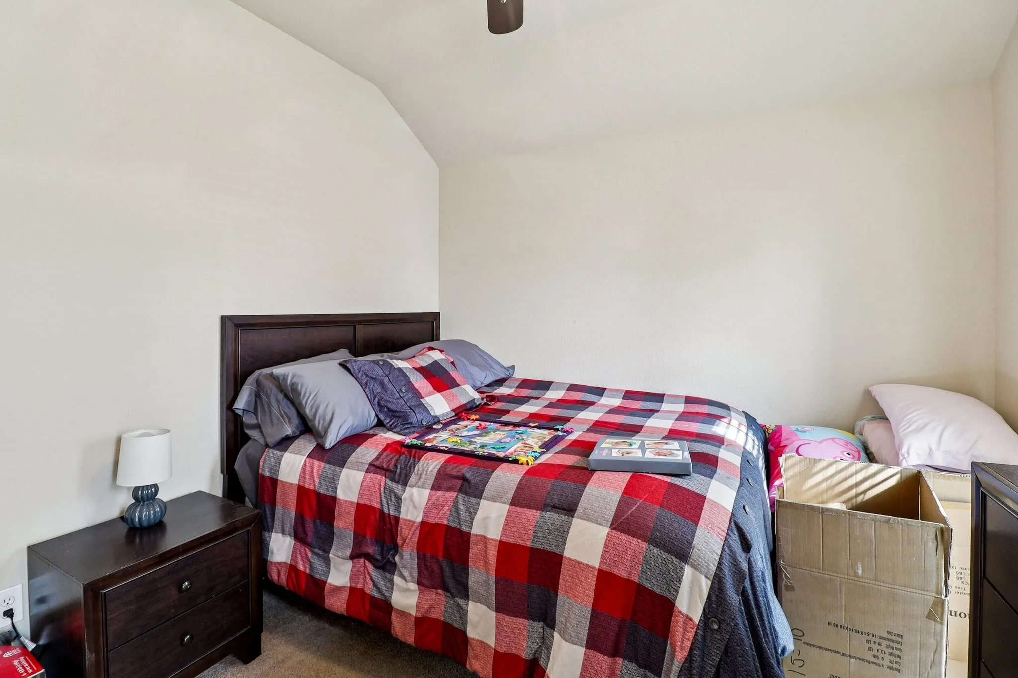 Bedroom featuring vaulted ceiling, a ceiling fan, and carpet flooring