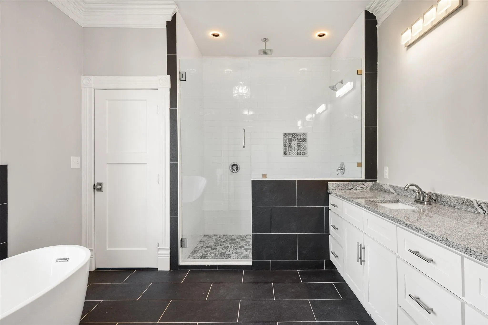 2nd floor primary bathroom with dual vanity, walk-in shower, self-standing tub