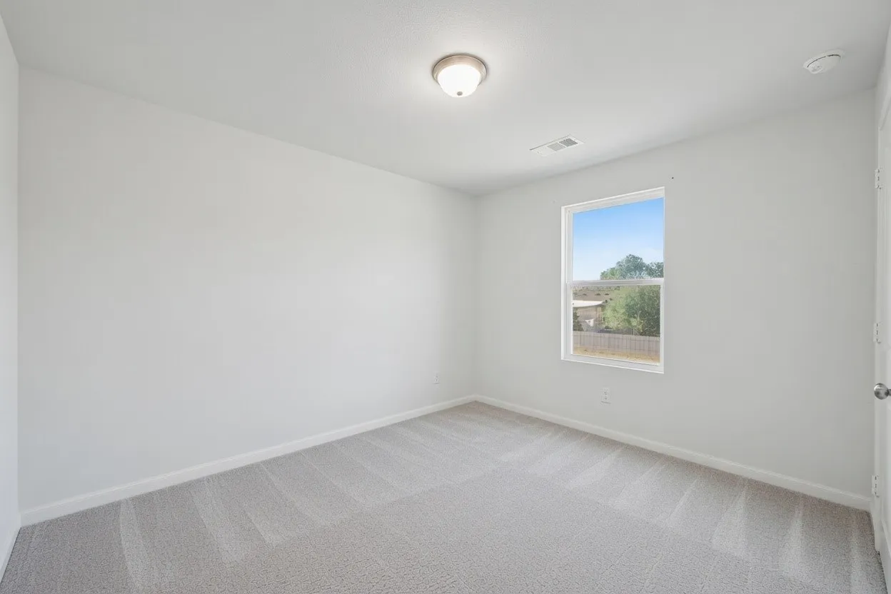 Bedroom featuring carpet floors and baseboards