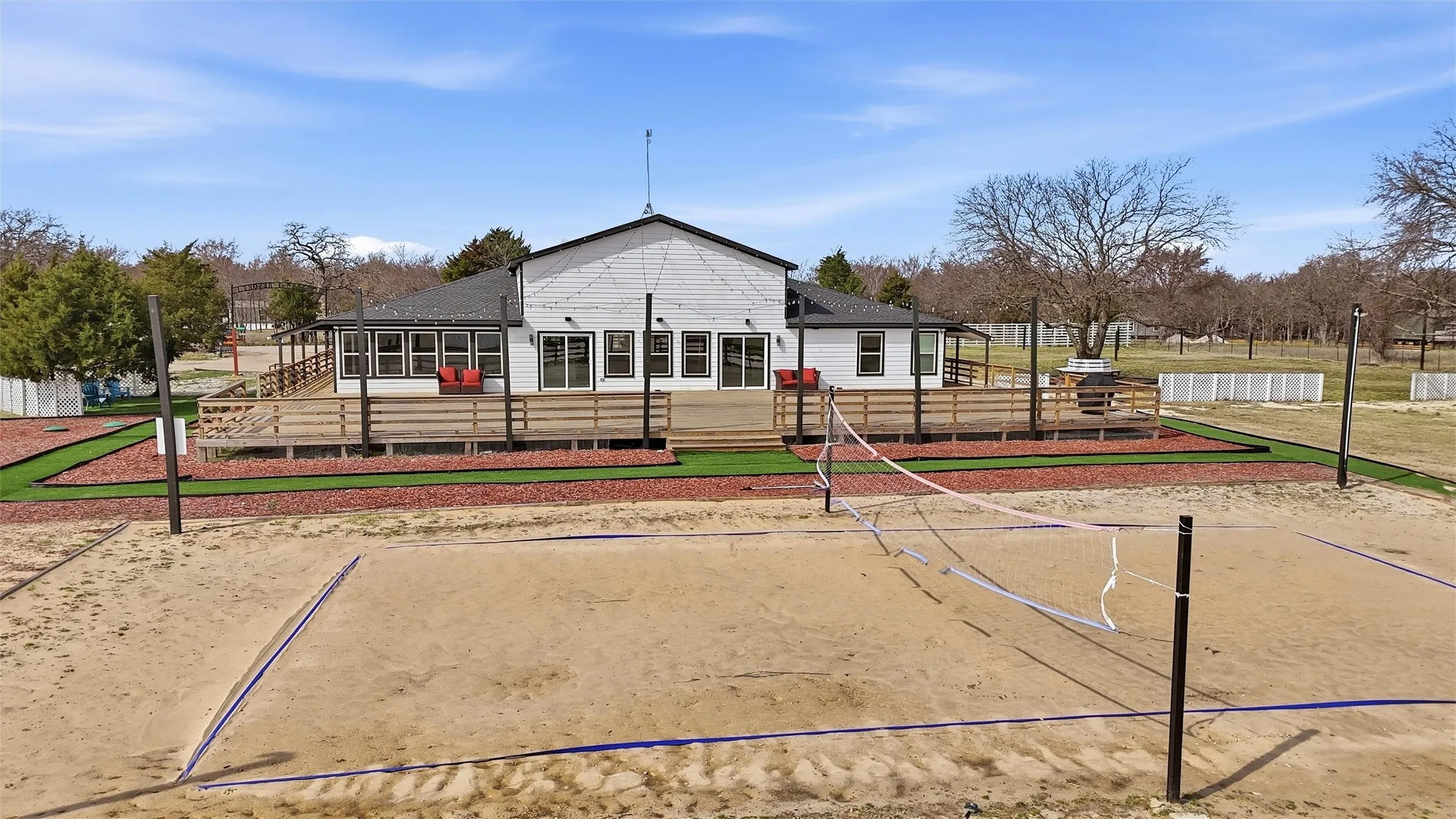 View of sand volleyball court and back deck.