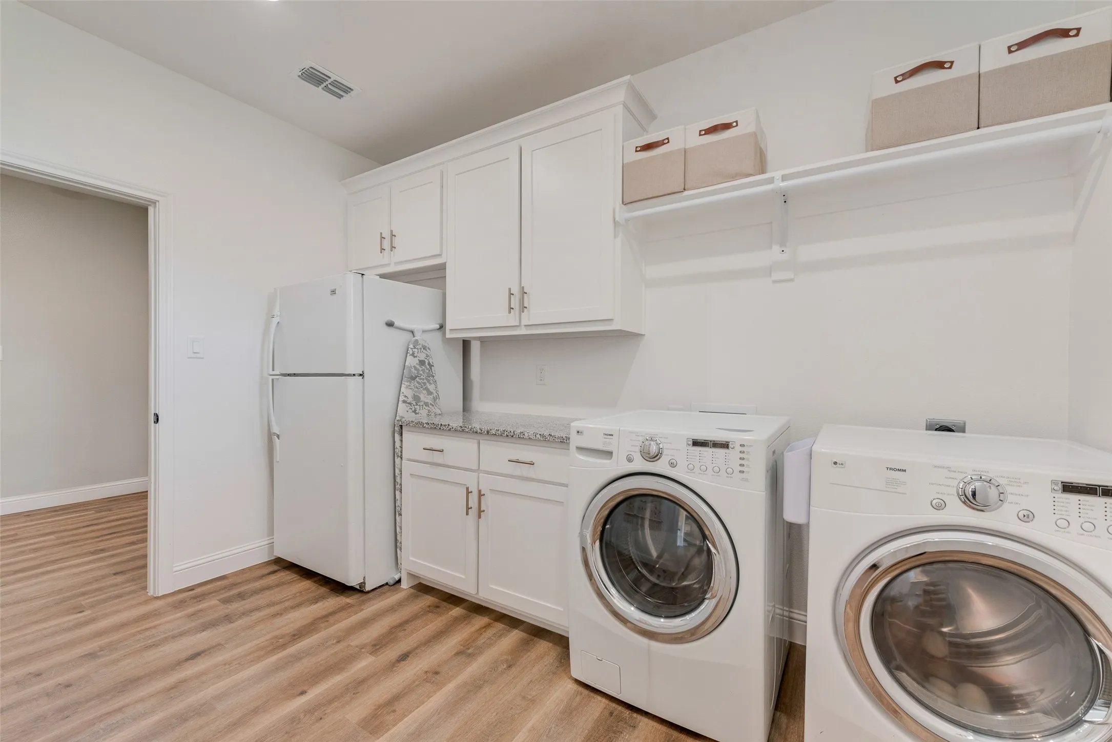 Laundry area is also off of the kitchen and has room for an additional fridge or freezer.
