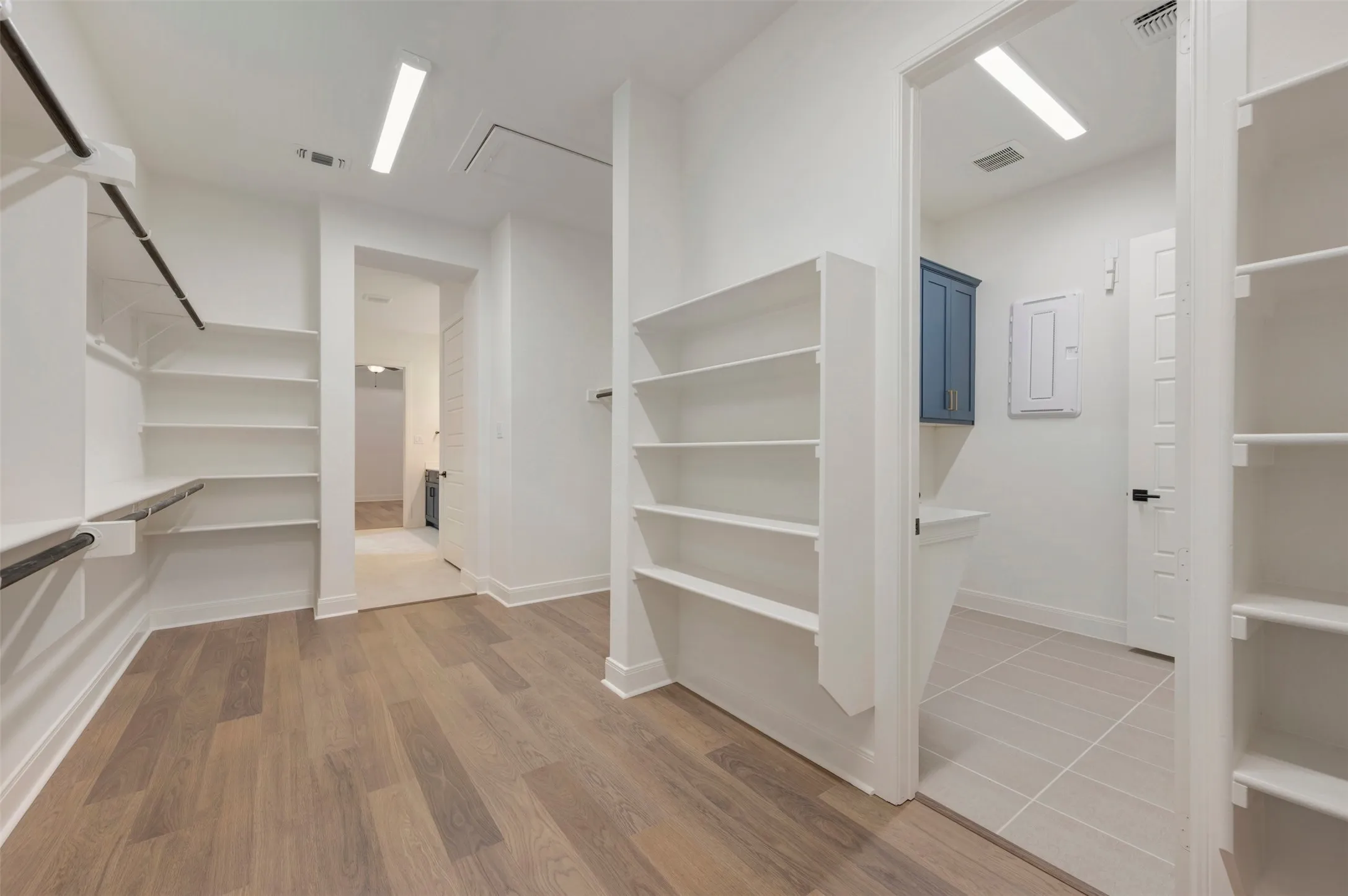 This spacious room features light wood-look flooring and ample shelving, providing extensive storage solutions