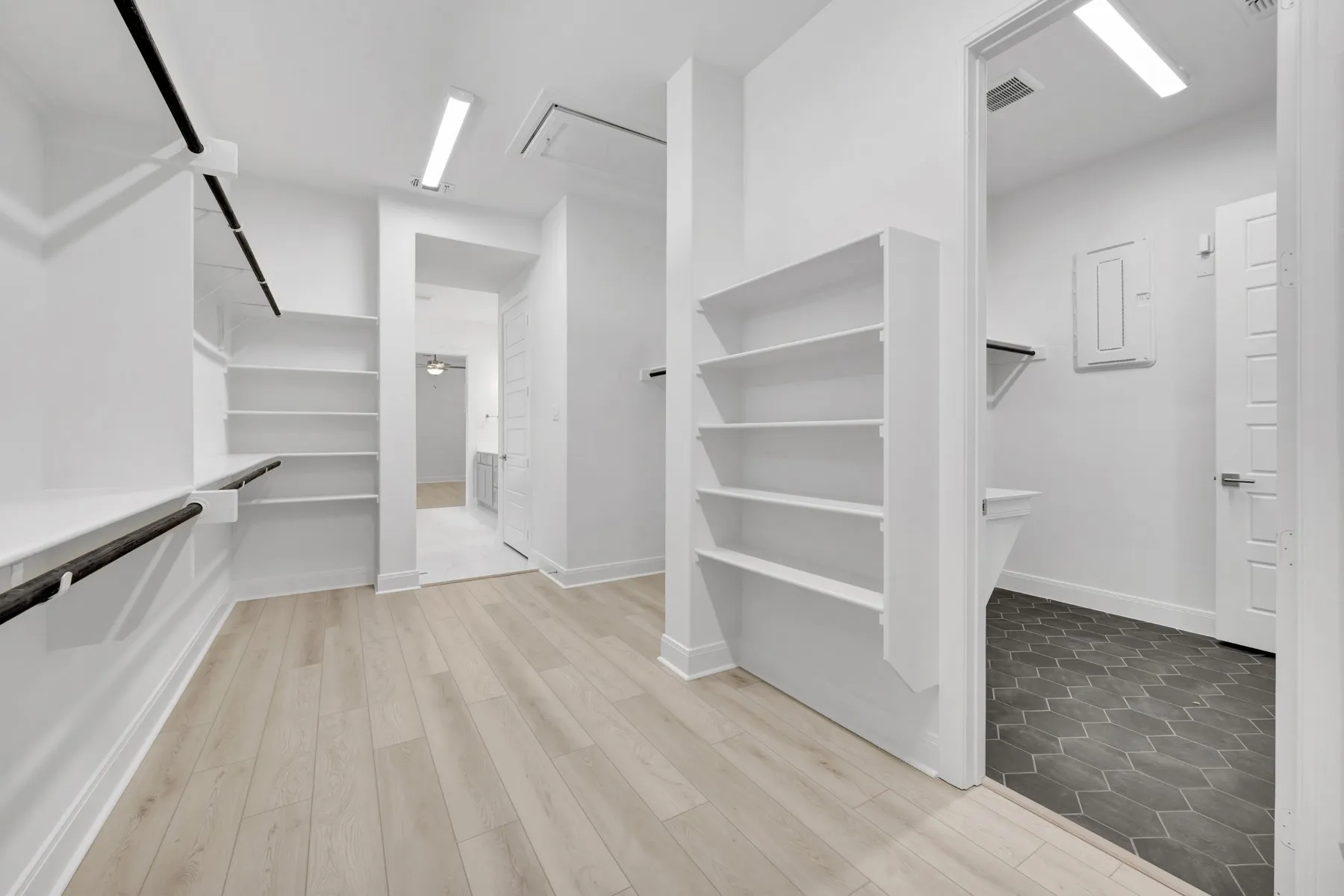 Walk in closet with light wood-style flooring