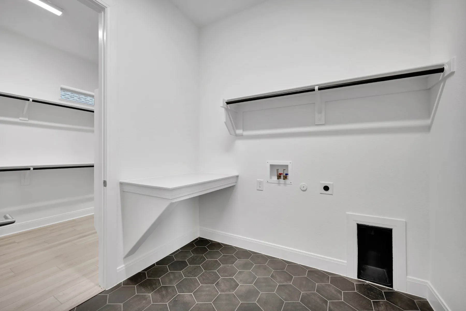 Laundry area with gas dryer hookup, washer hookup, electric dryer hookup, and dark tile patterned floors