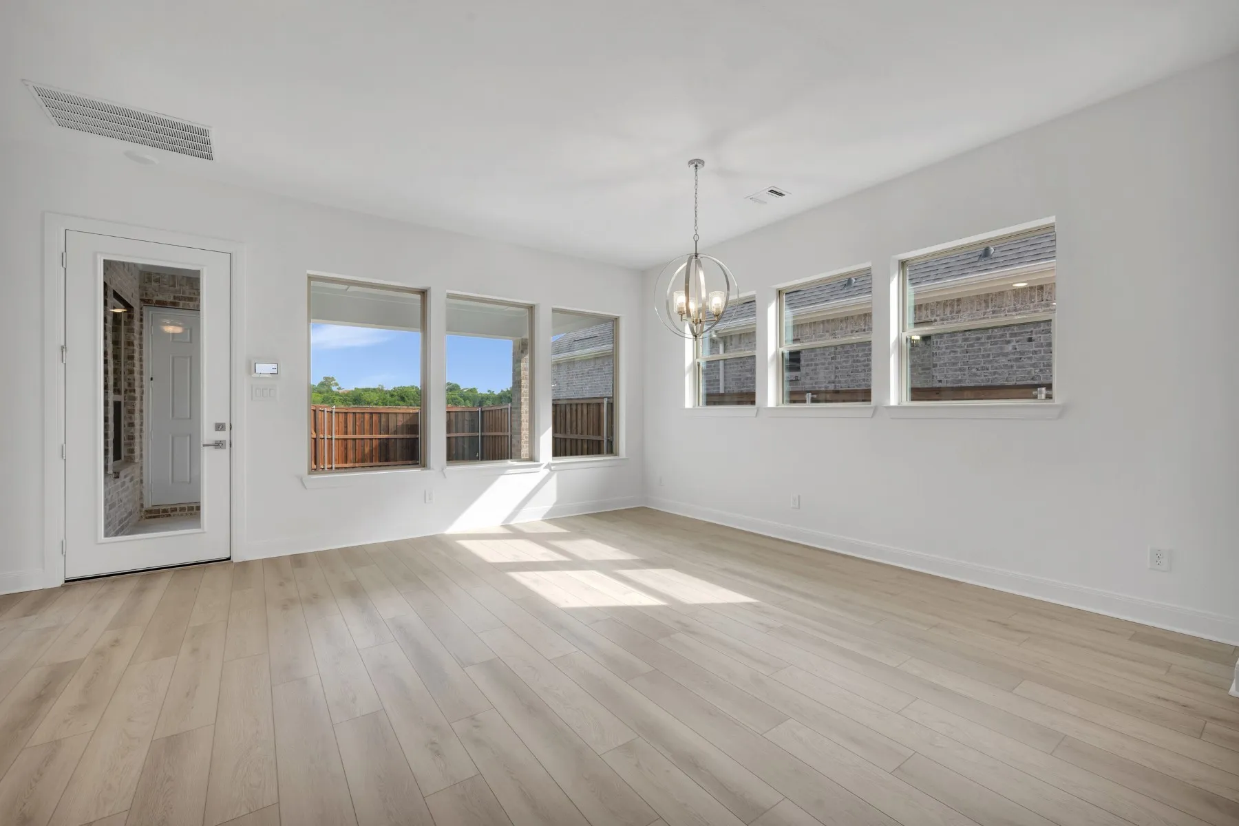 Unfurnished room featuring a chandelier and light wood finished floors