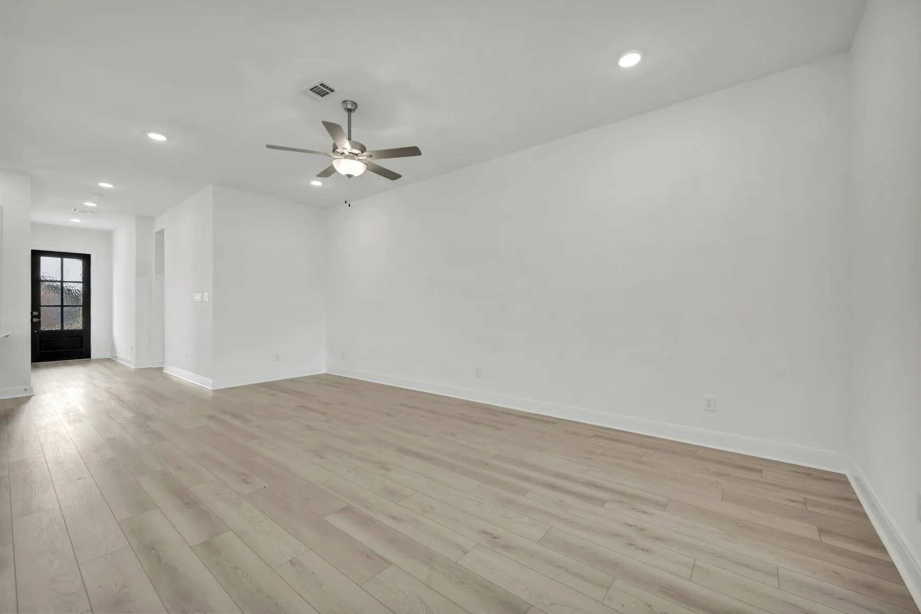 Spare room featuring recessed lighting, a ceiling fan, and light wood-style floors